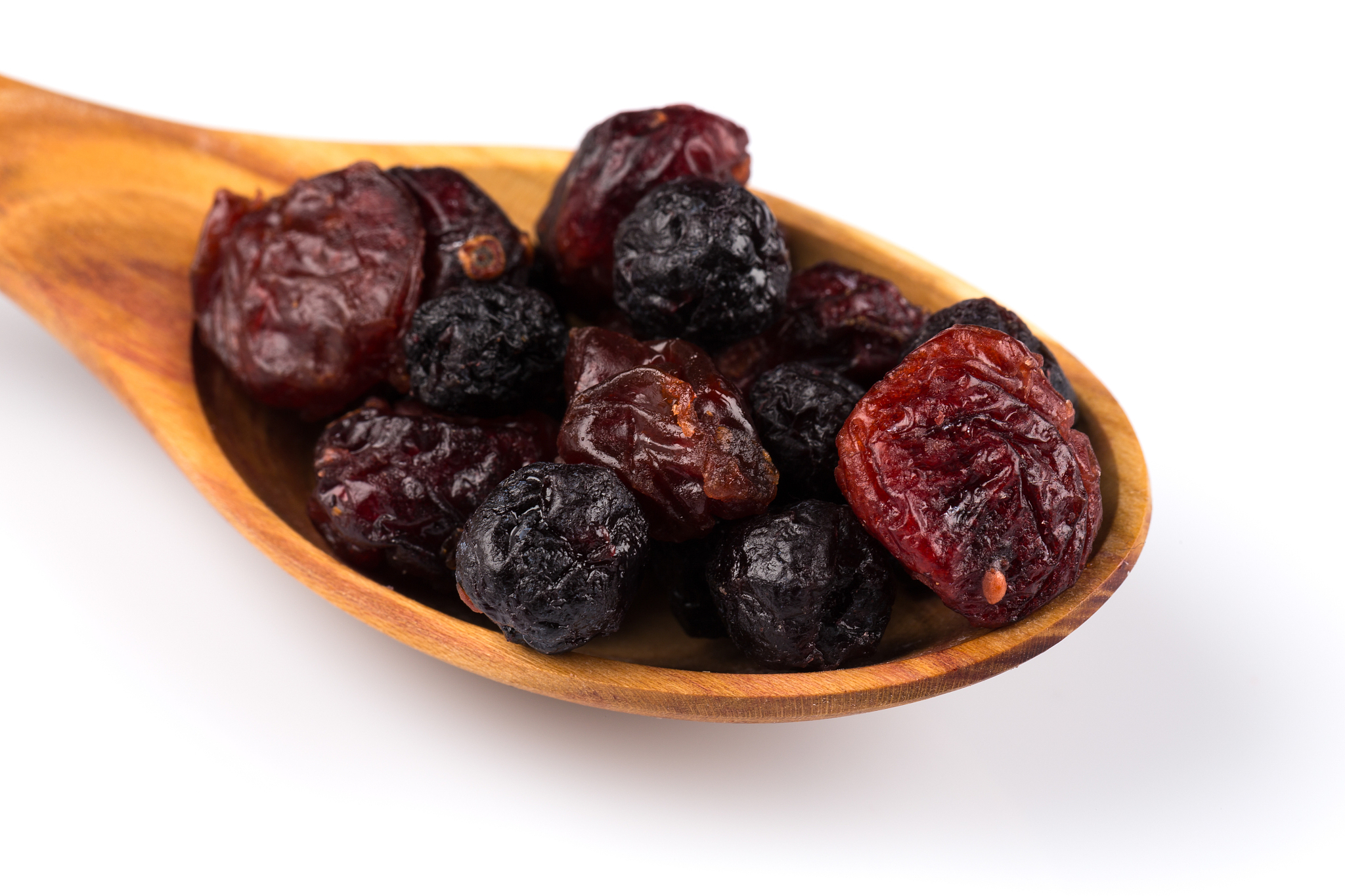 dried cranberries, cherries and blueberries on white background