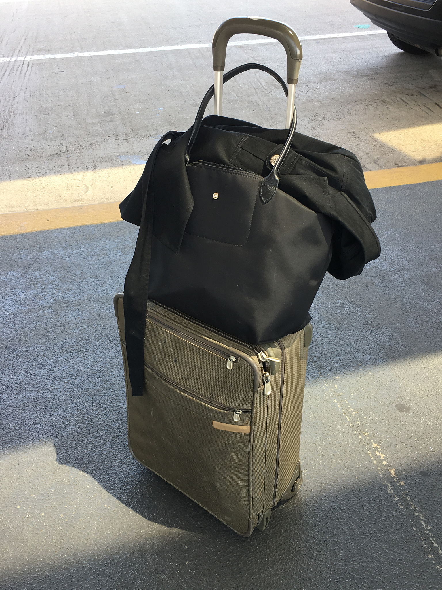 a frequent travelers's suitcase curbside at o'hare airport waiti