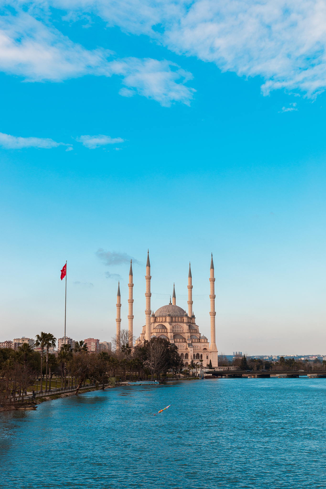 sabanci central mosque, old clock tower and stone bridge in adan