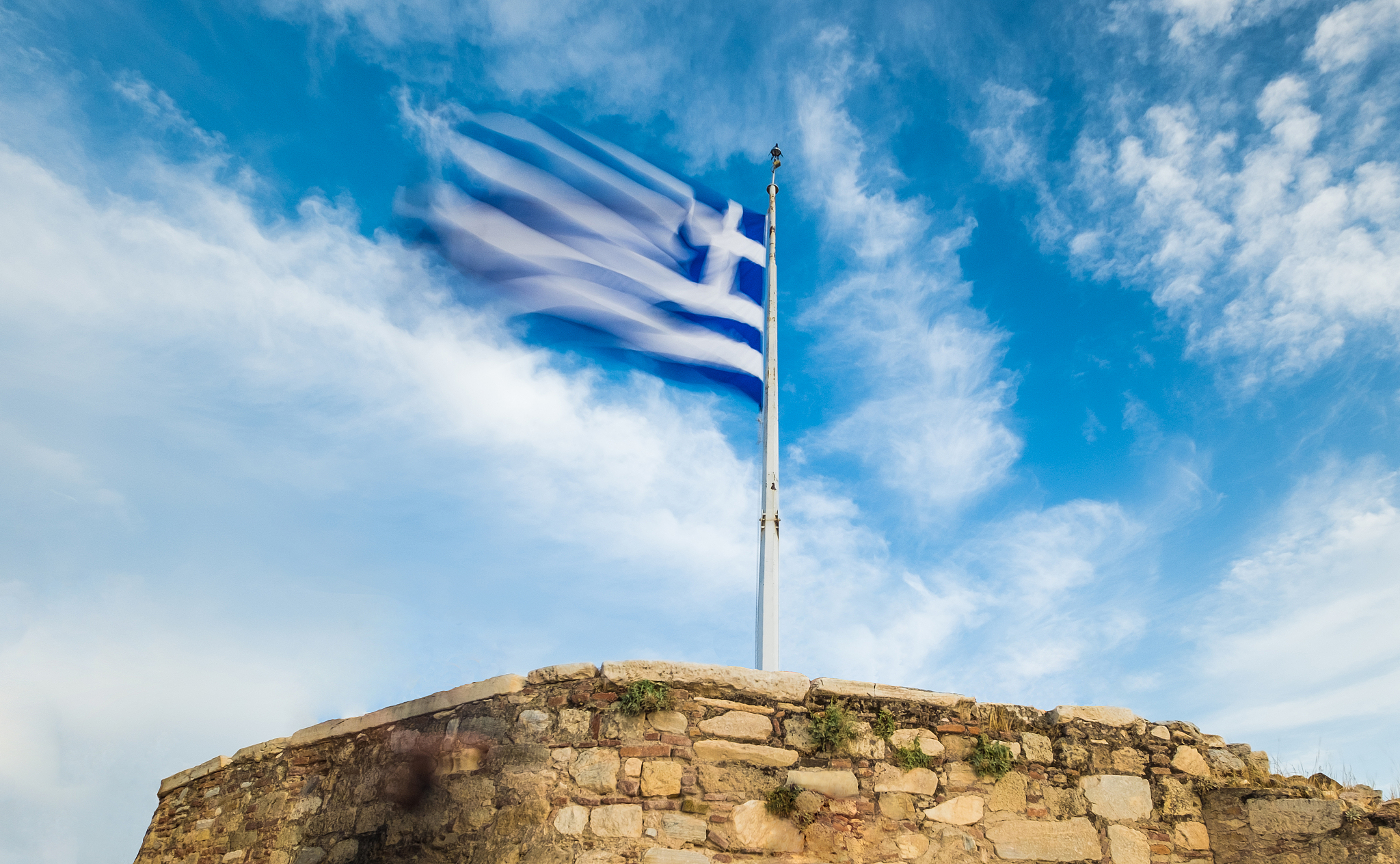 greek flag waving against blue sky