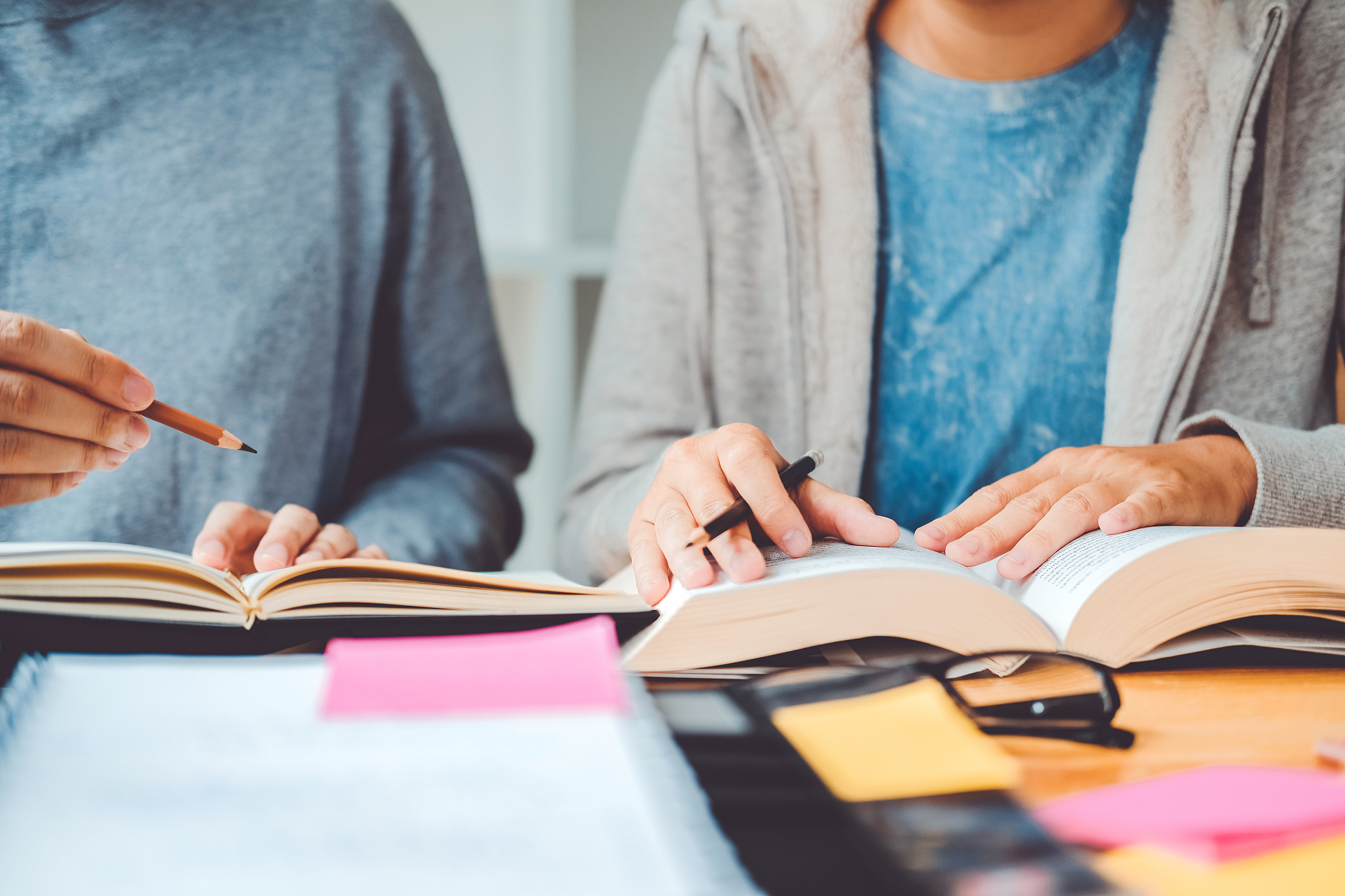 high school or college students studying and reading together in