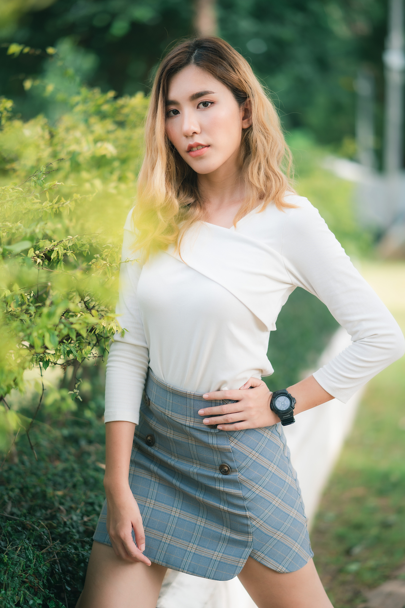 portrait of beautiful young woman standing by plants