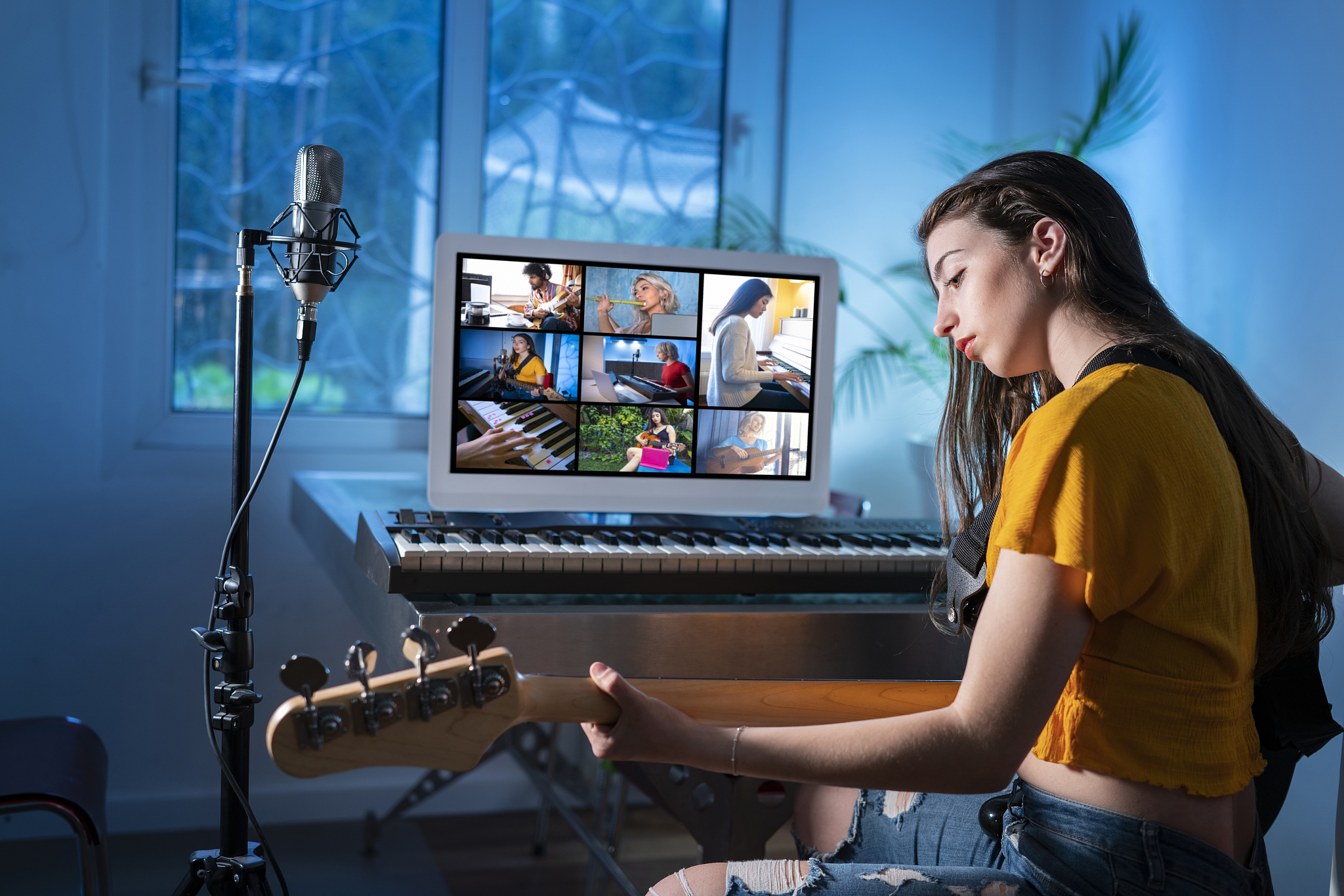 brunette teenager girl playing bass guitar music teleconference 