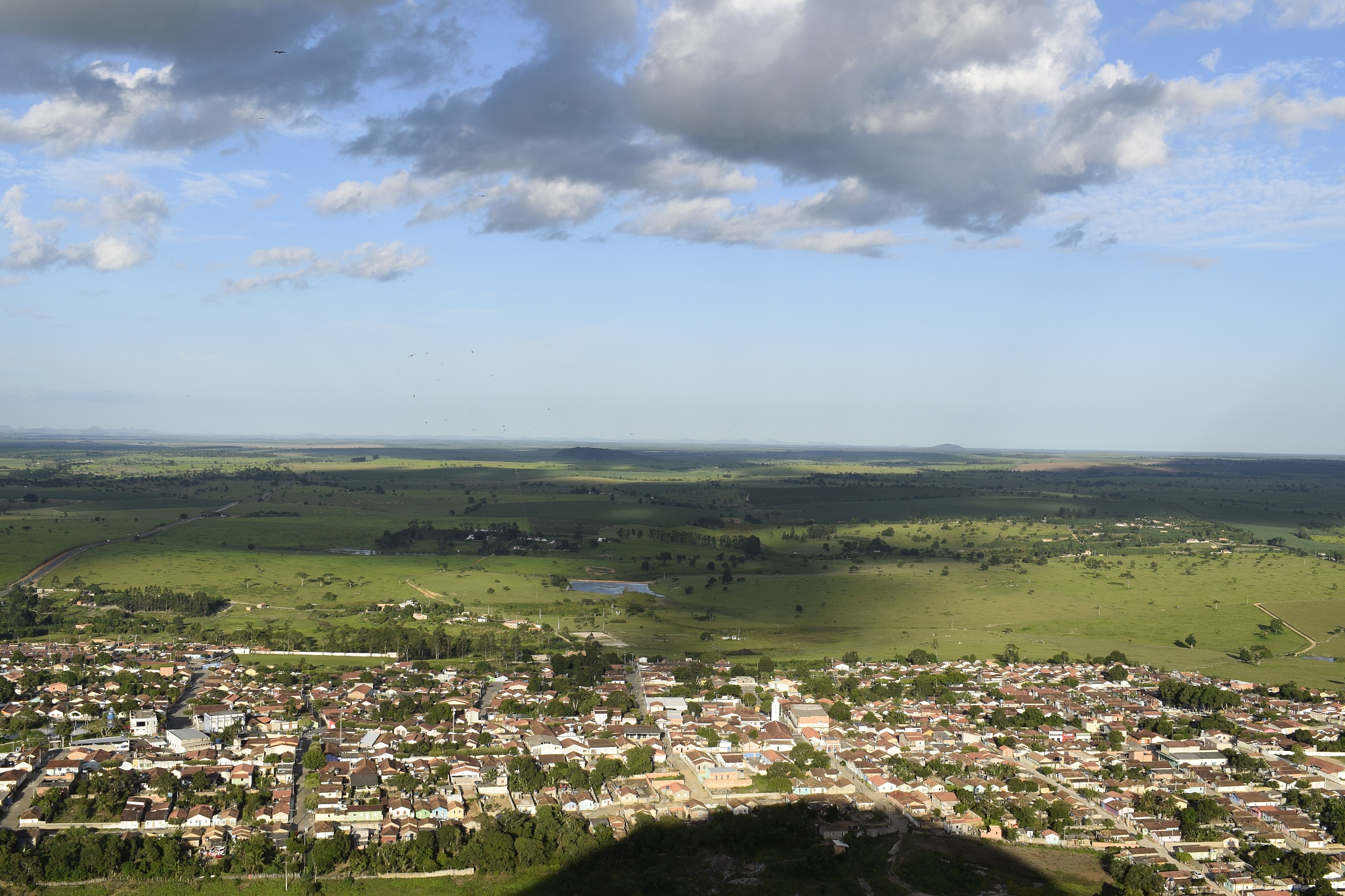 small city around by a green meadow horizon (lagedao, bahia)