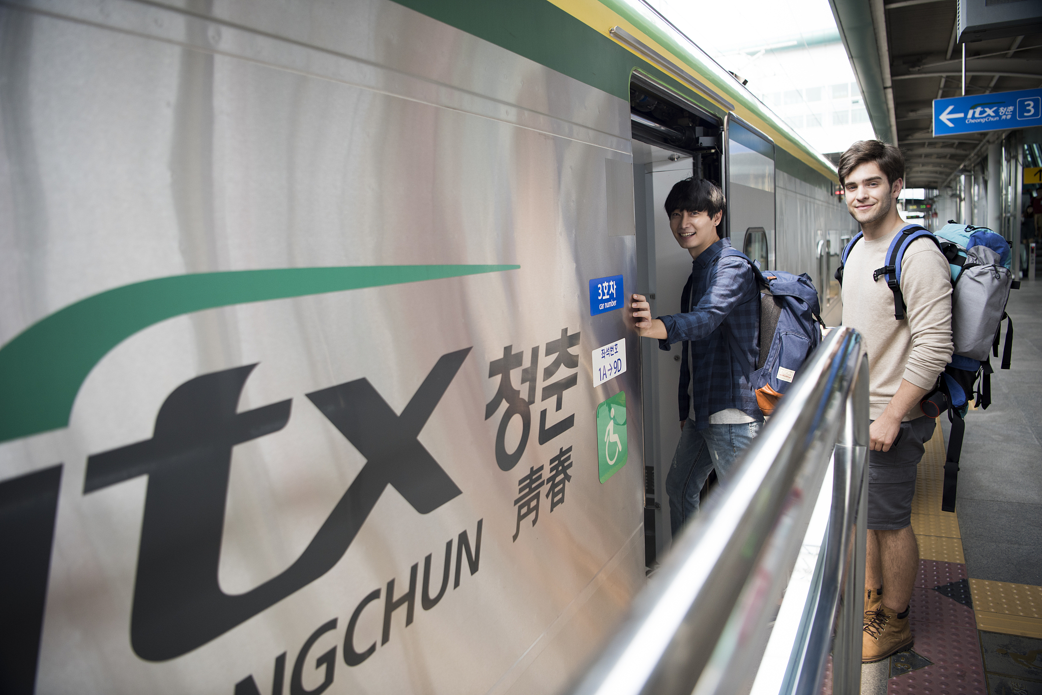two man tourists getting on the train