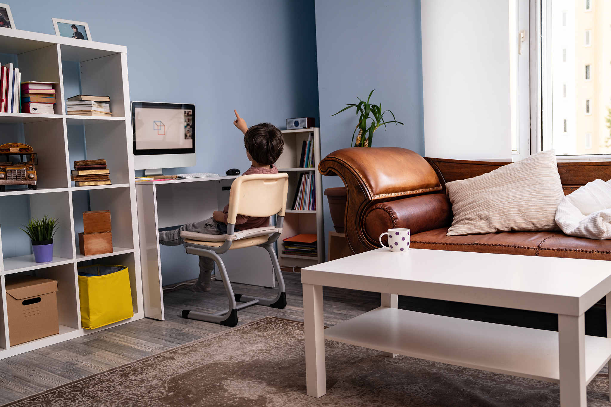 school boy having online education at home
