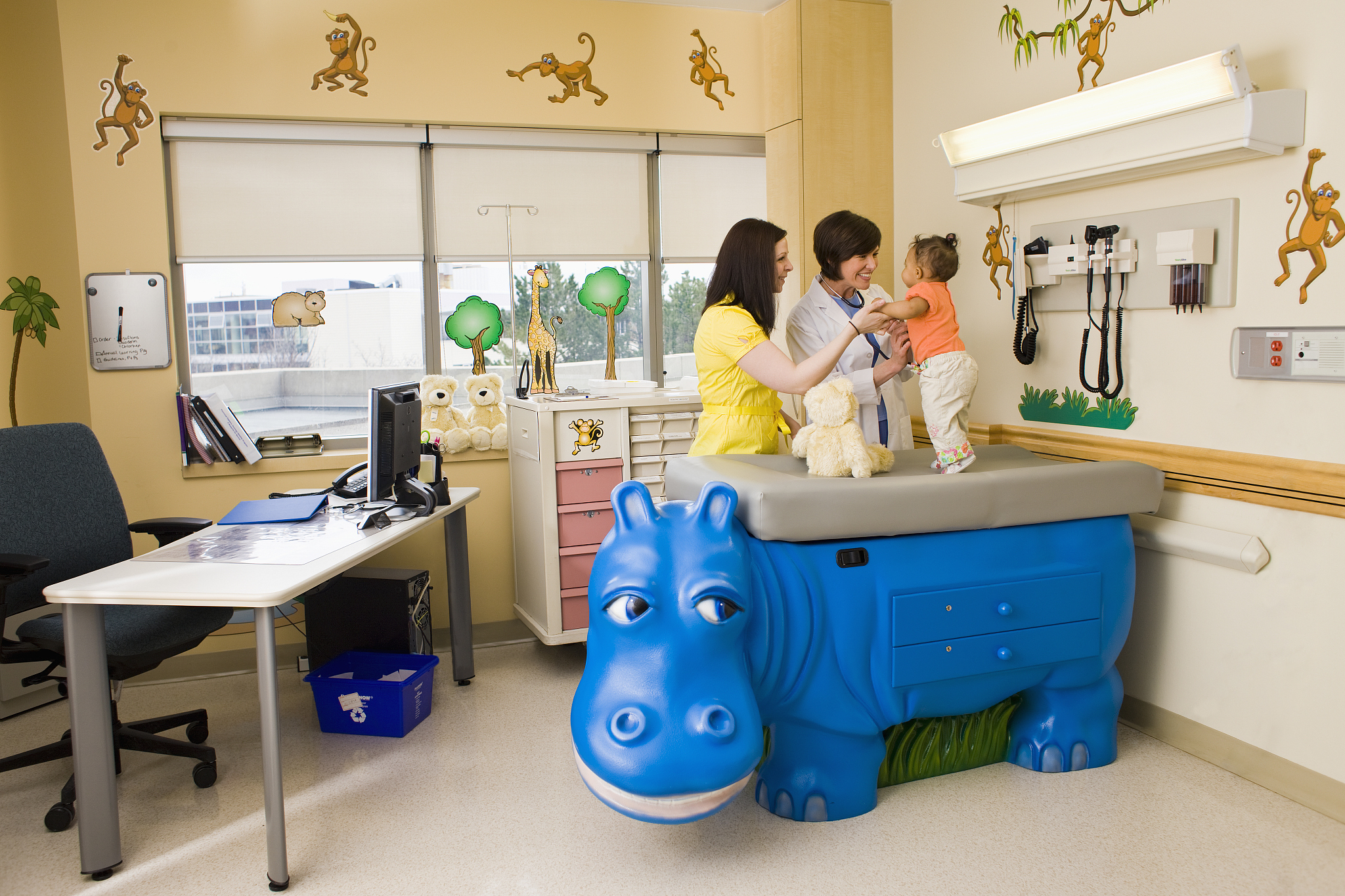 doctor examining baby in pediatric examination room