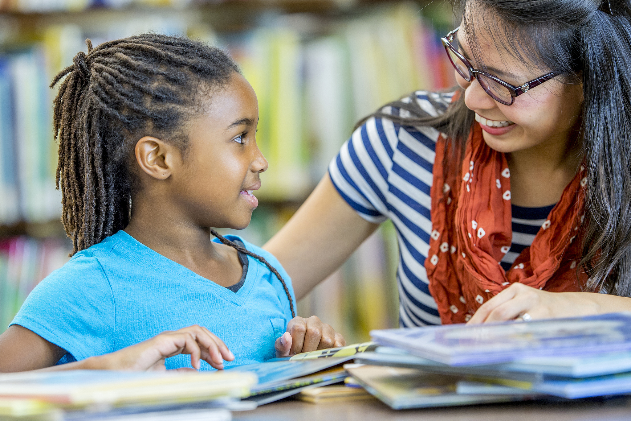 girl getting help from teacher