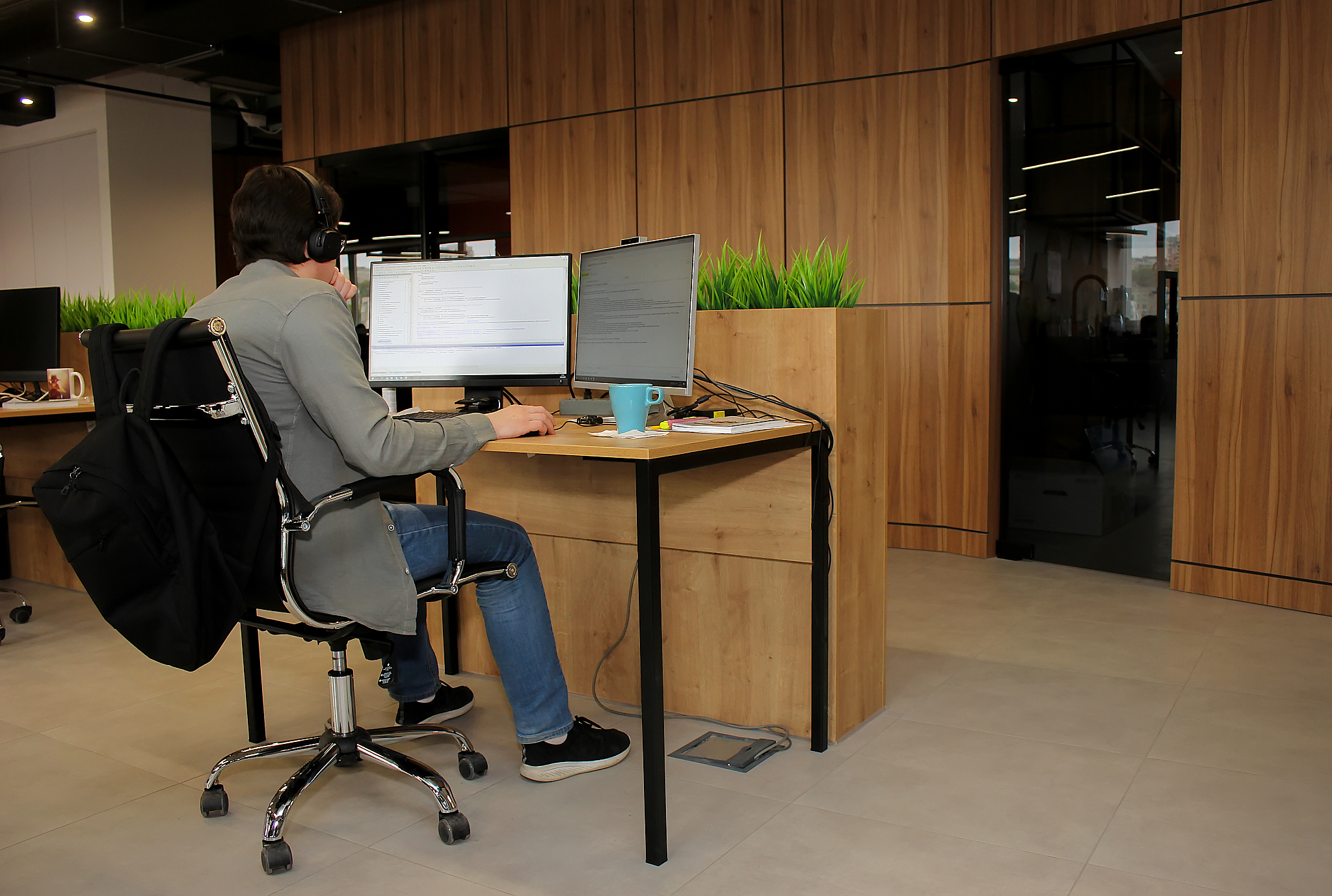 young employee looking at computer monitor during working day in