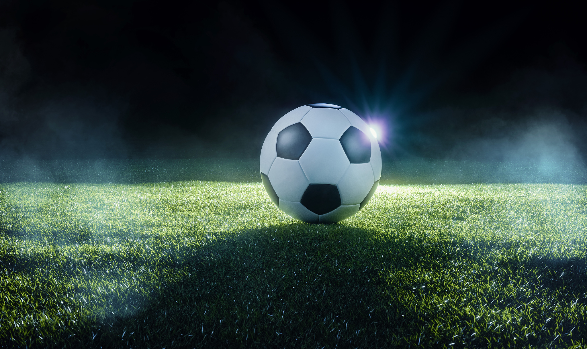 football on an illuminated sports field at night