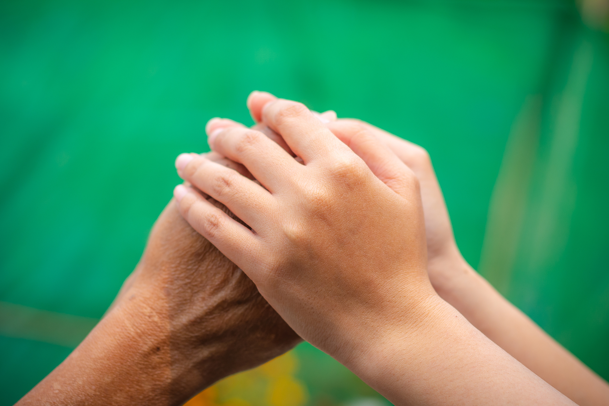 asian senior and asian young holding hands.