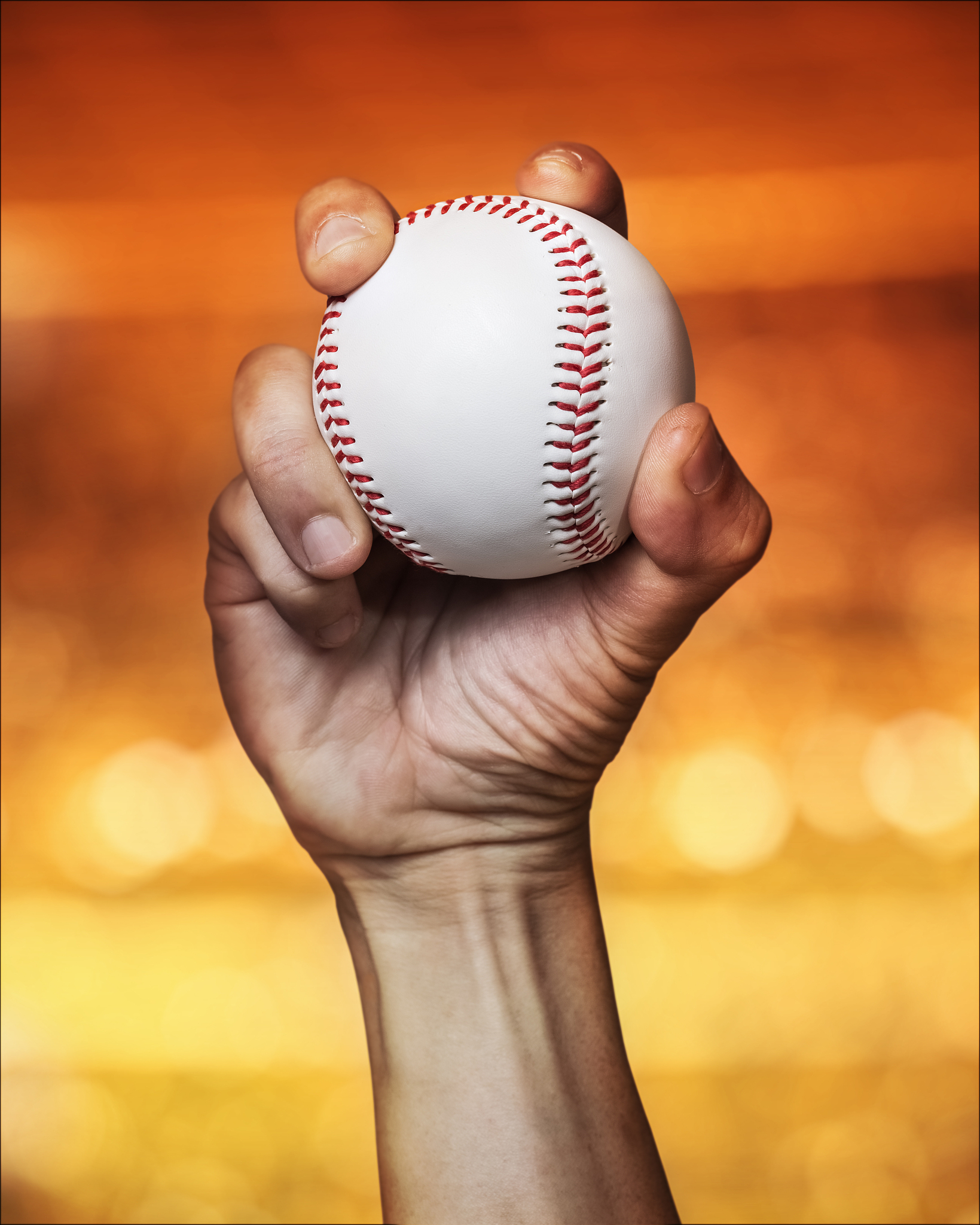 close up of baseball with male hand