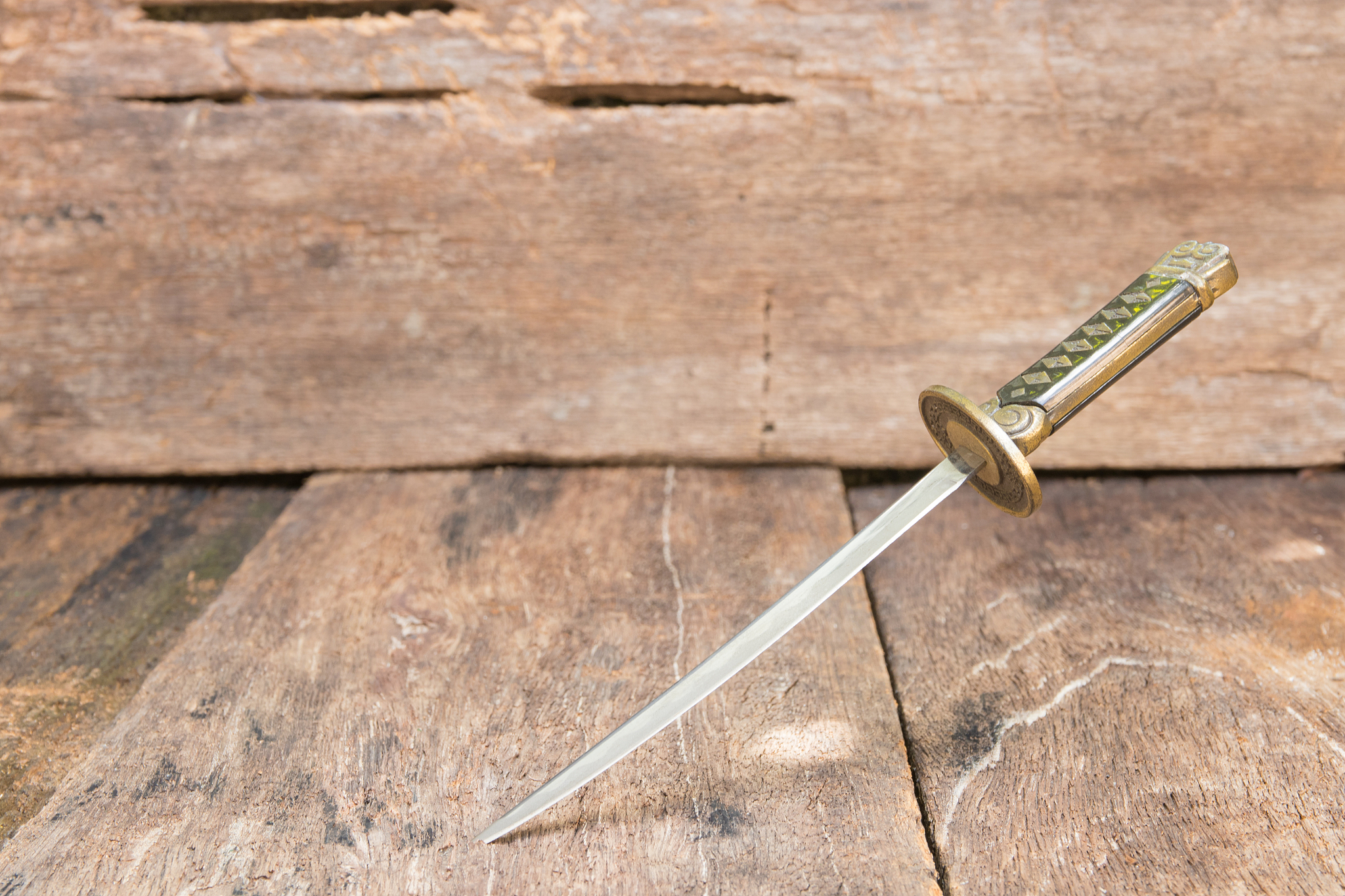 sword steel blade samurai pierce on old wooden surface floor wit