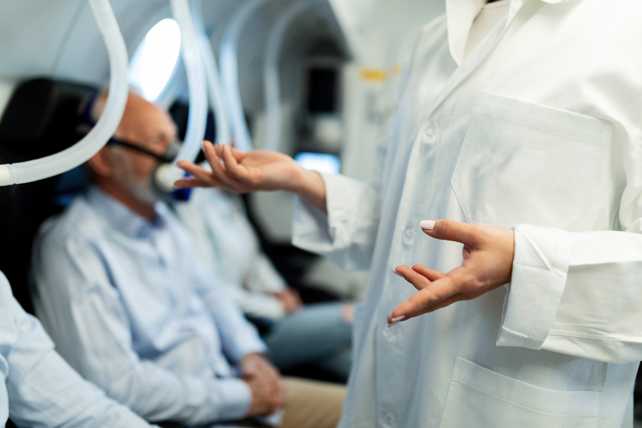 unrecognizable doctor talking to a patient in hyperbaric chamber