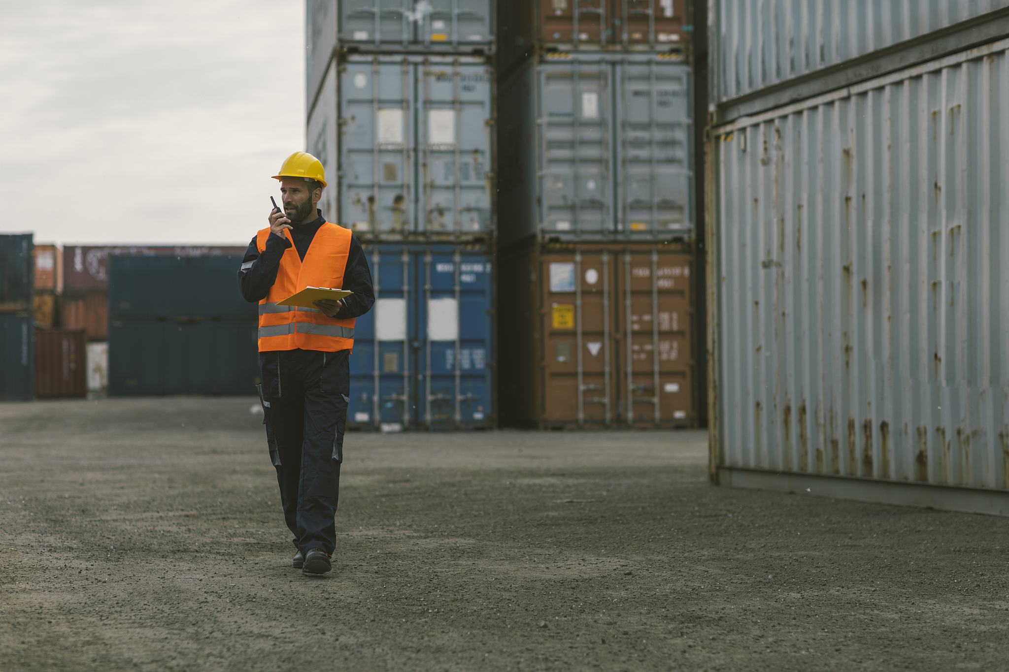 manual worker checking cargo containers