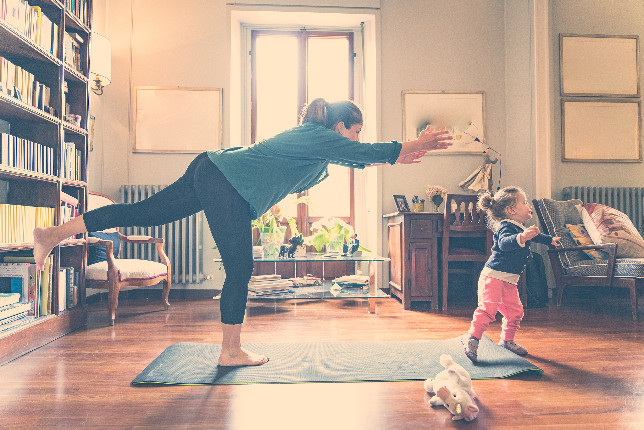 woman staying at home exercising with her daughter