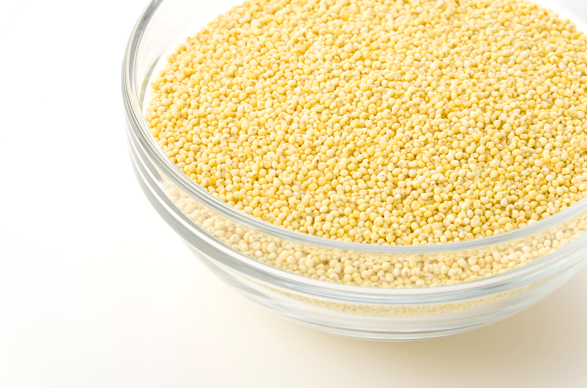 glutinous millet in glass bowl on white background