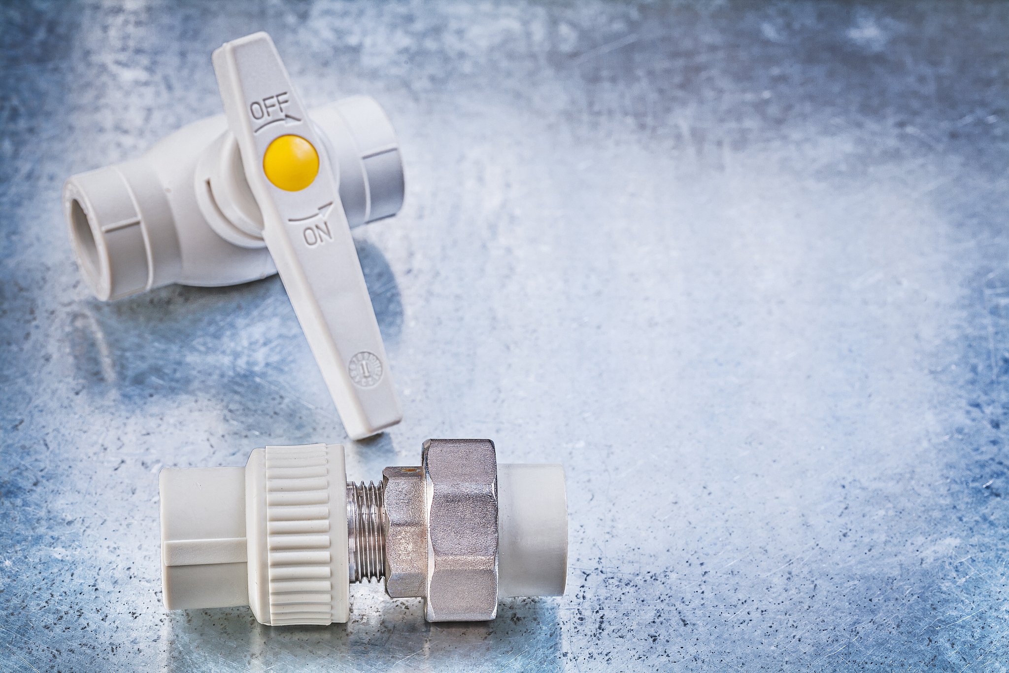water valve threaded pipe fitting on metallic background constru