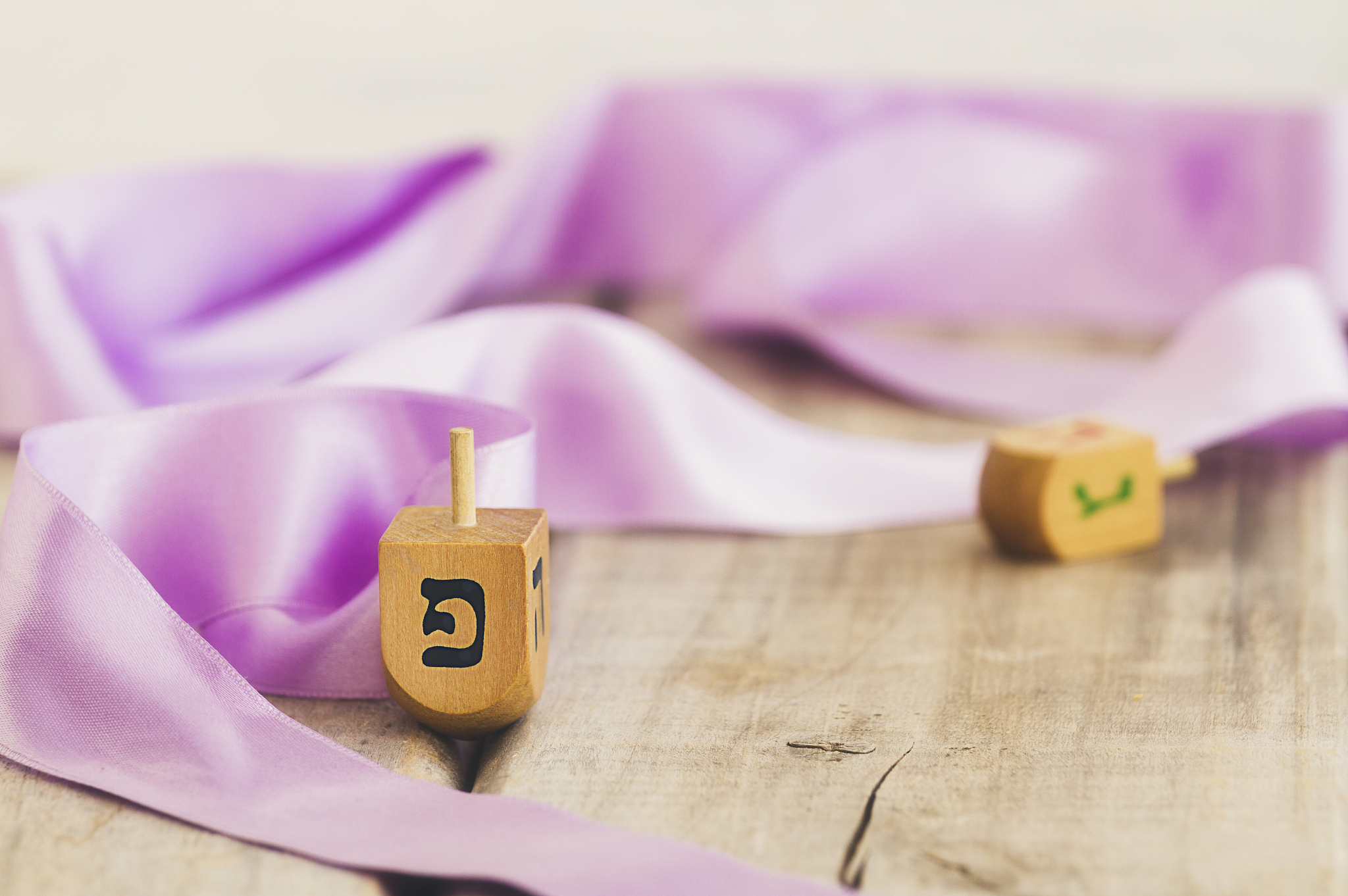hanukkah dreidels on a vintage wood background with copy space. 