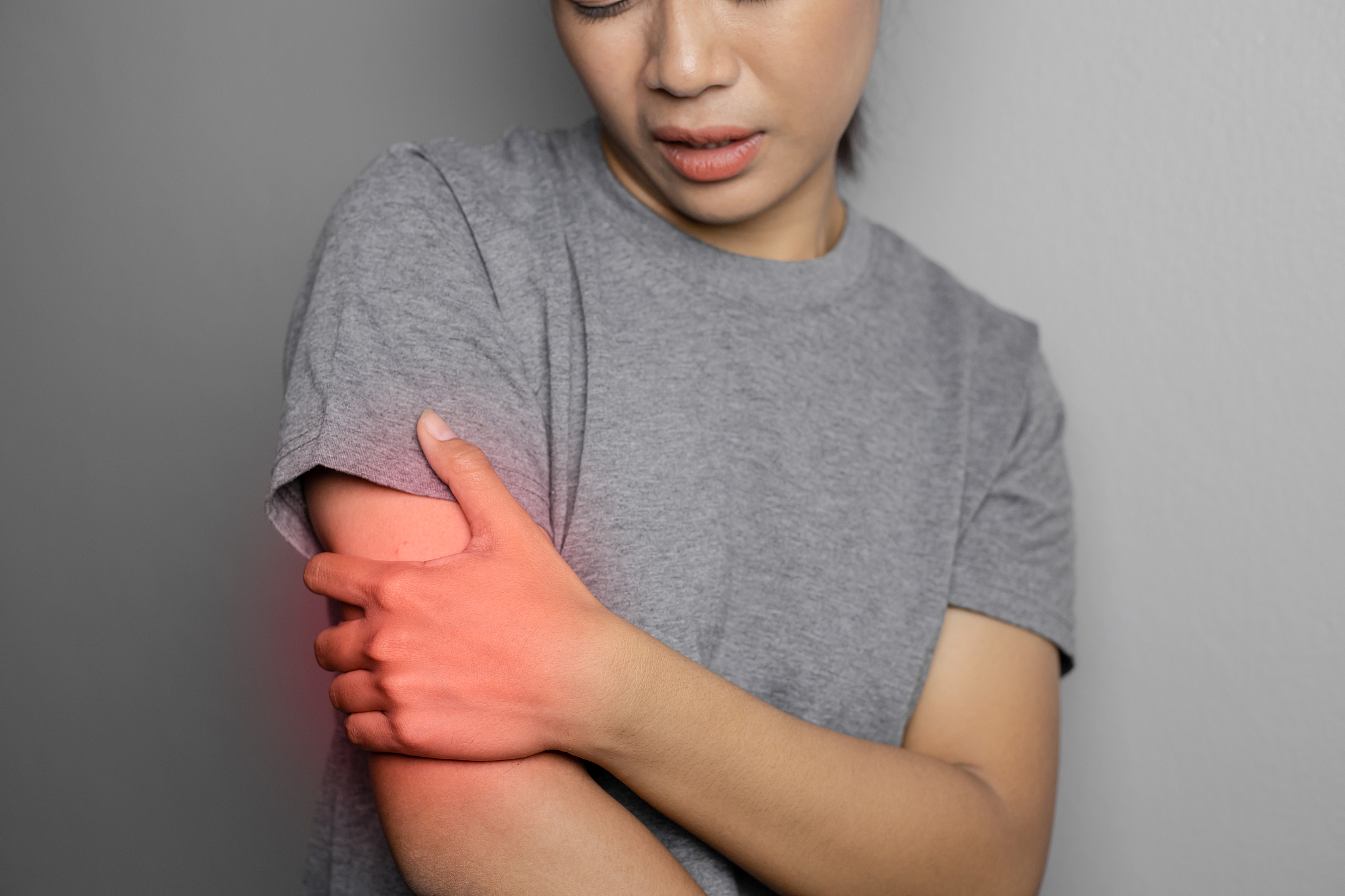 woman suffering from pain in arm.