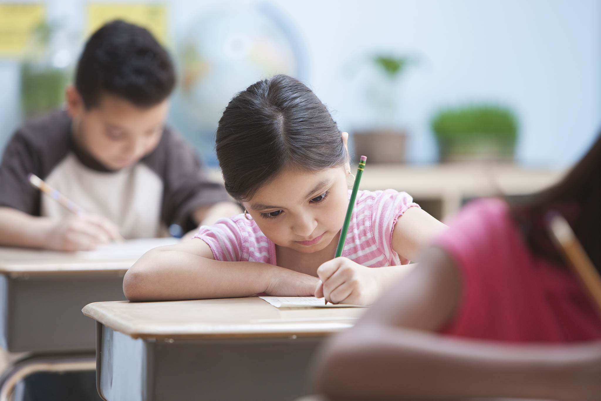 elementary students concentrating on test