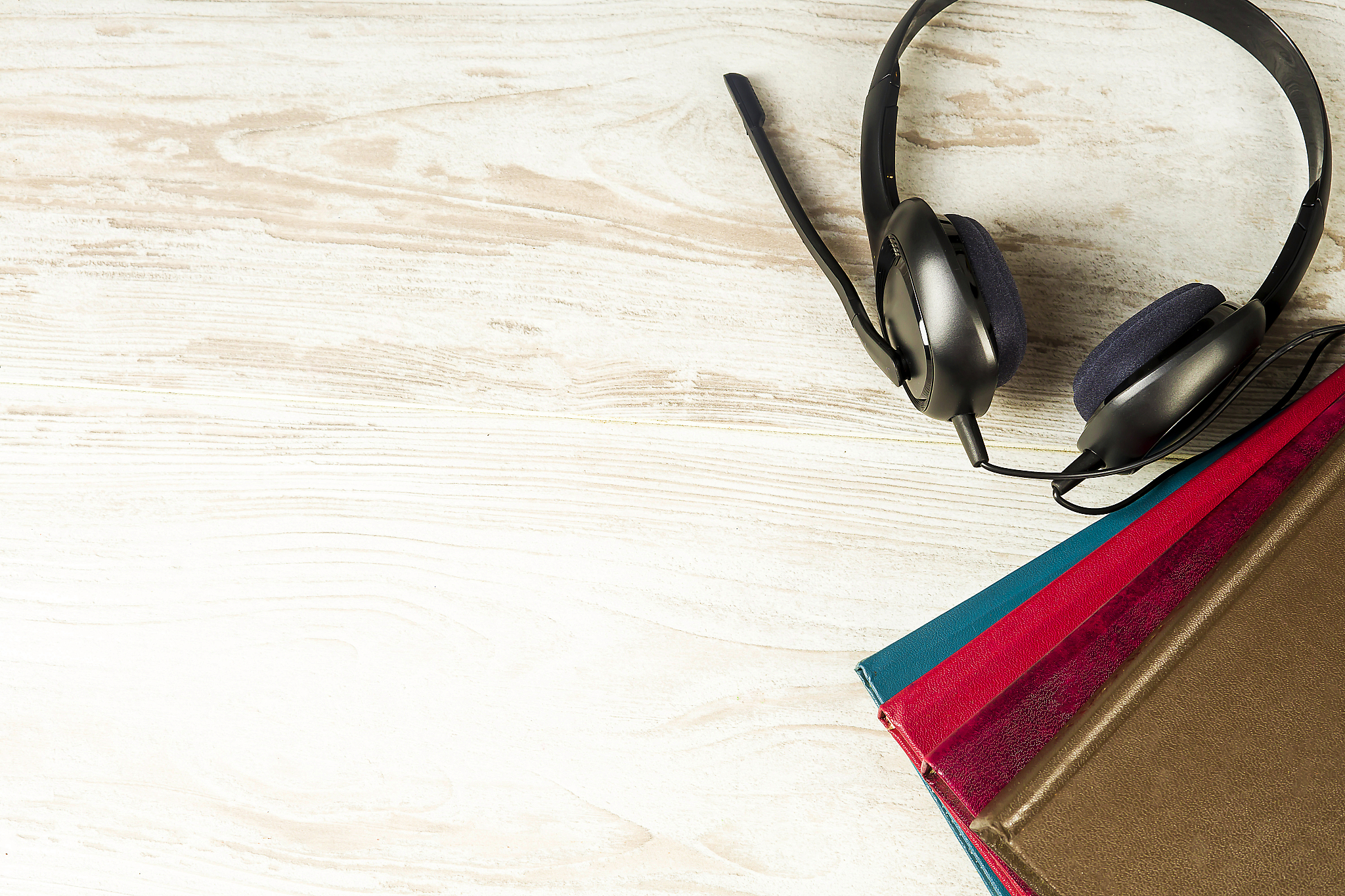 concept of audiobooks, headphones and books on a vintage backgro