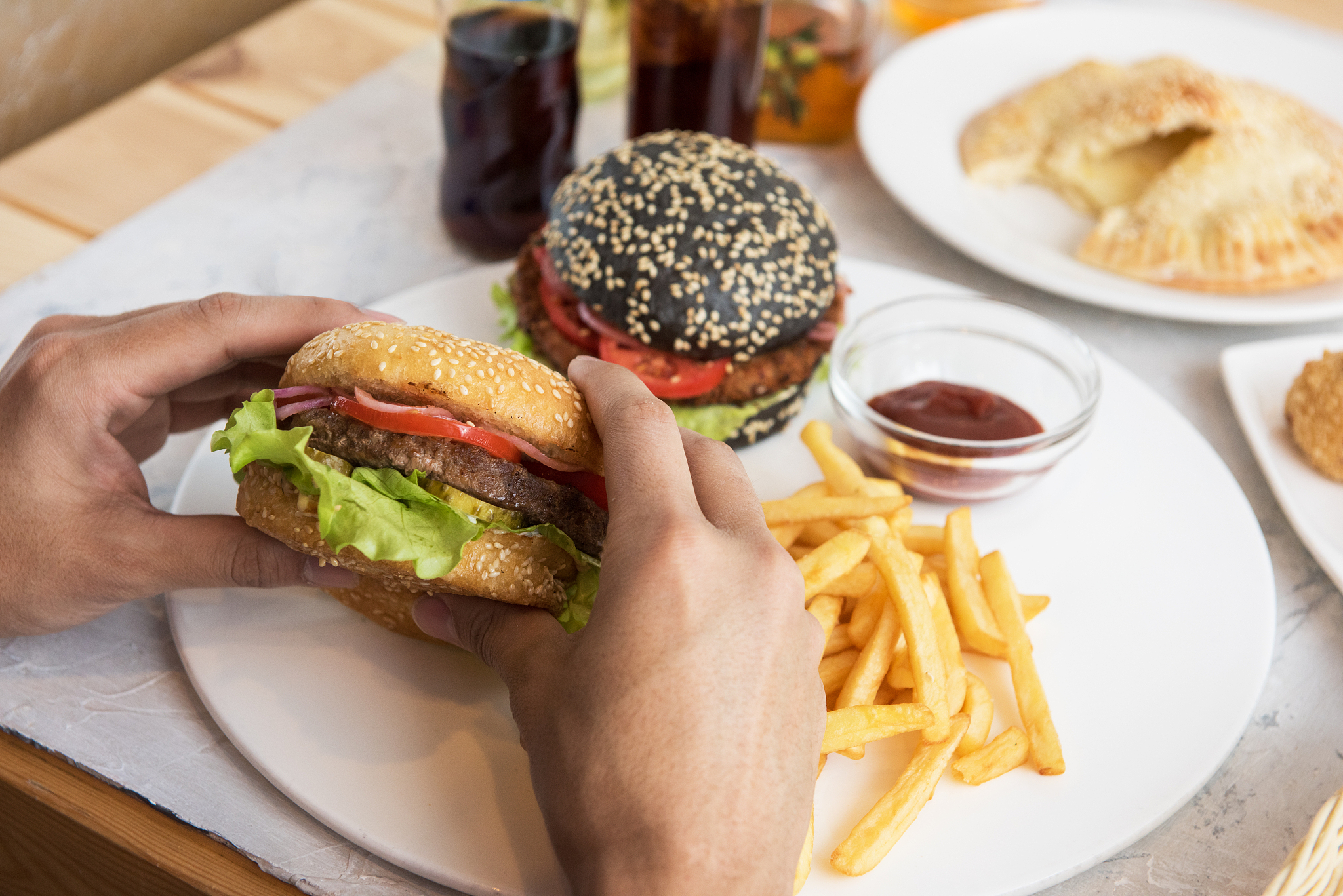 man eating burgers