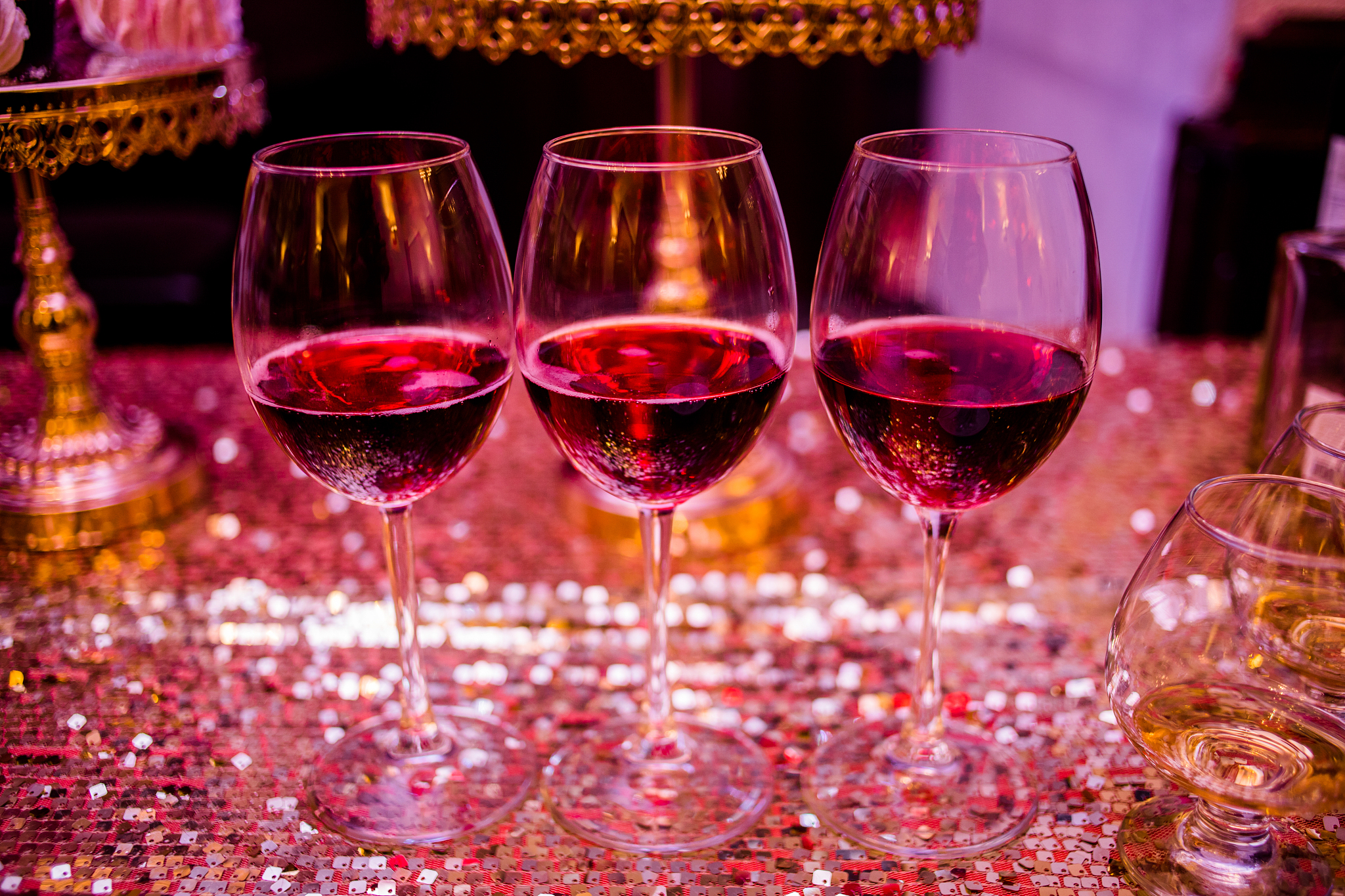 three glasses are full of wine