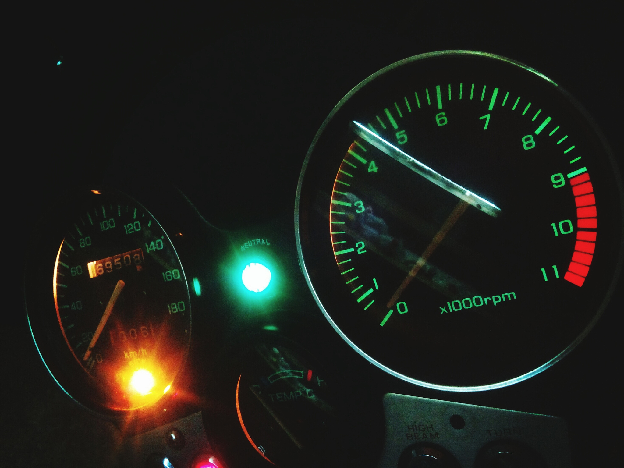 illuminated speedometer of motorcycle at night