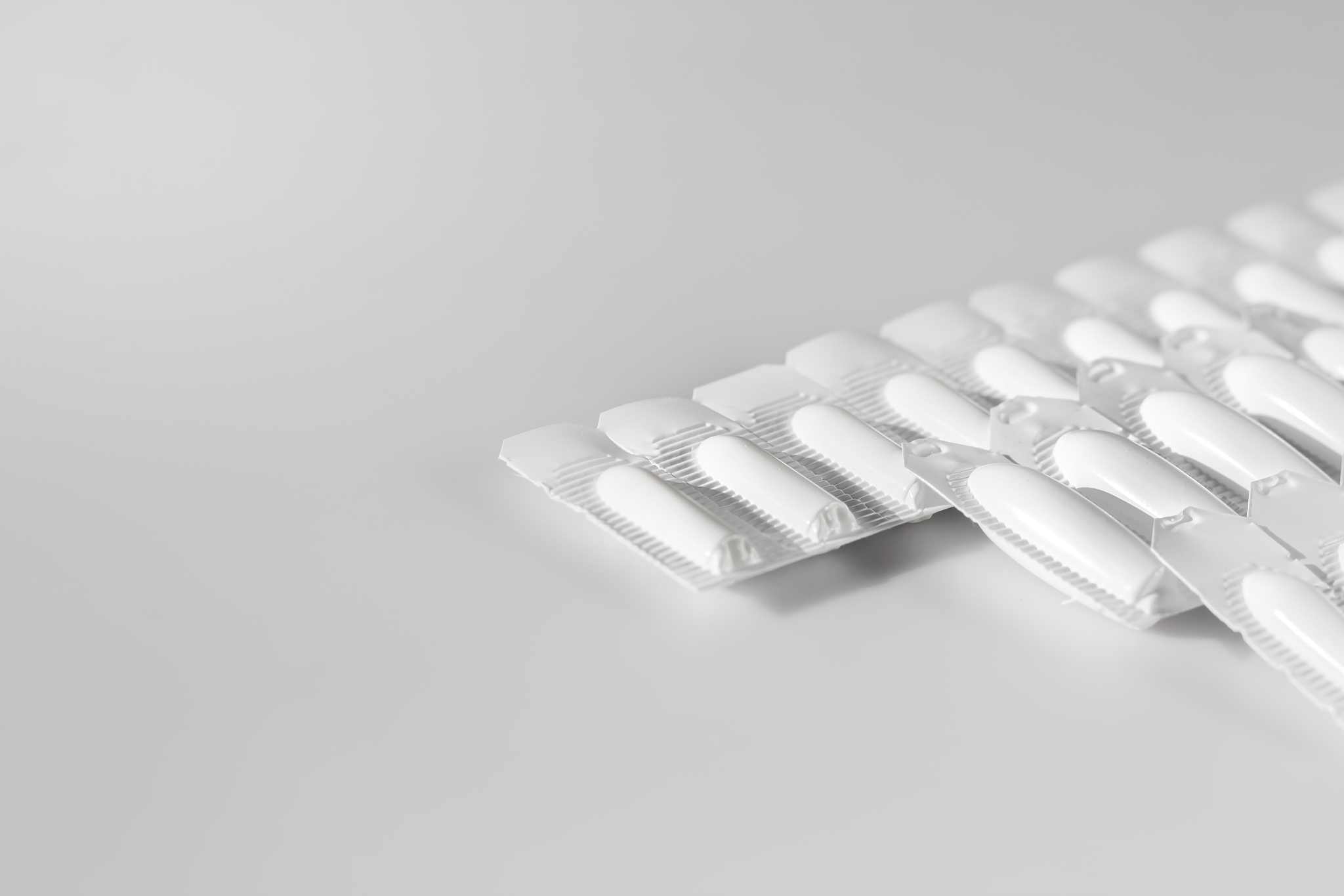 white medical suppositories in blister strip - pills on white ba