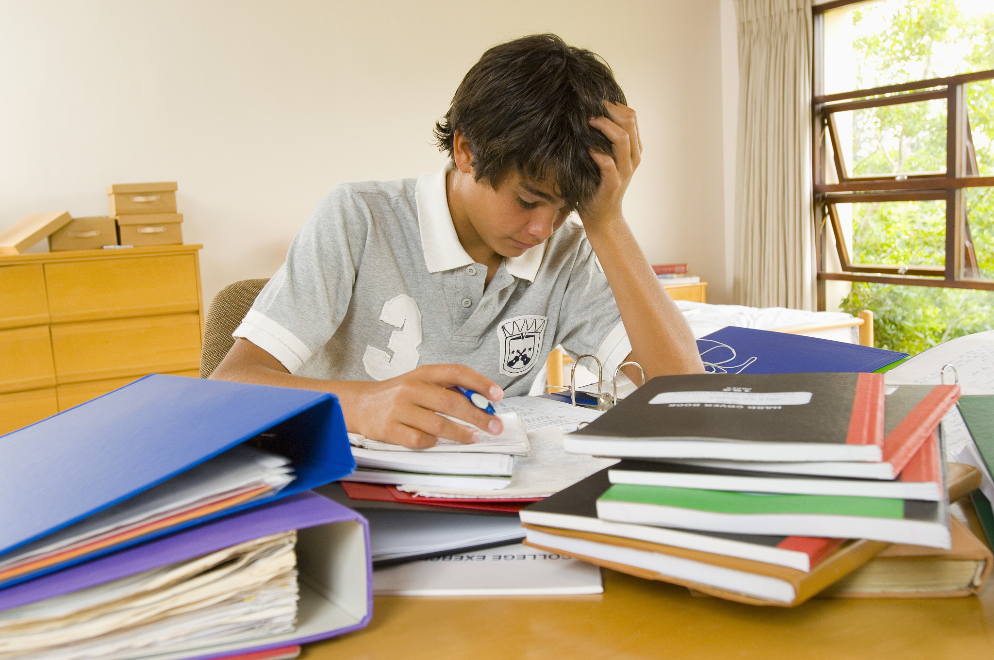 frustrated teenage boy doing homework