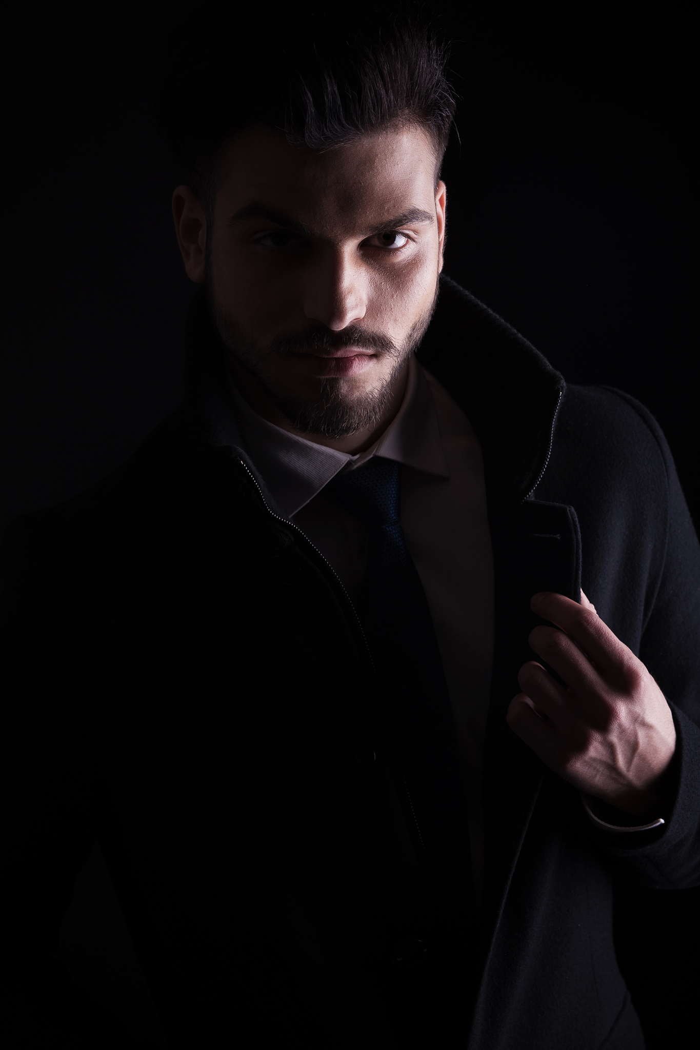 young business man holding his hand on the collar