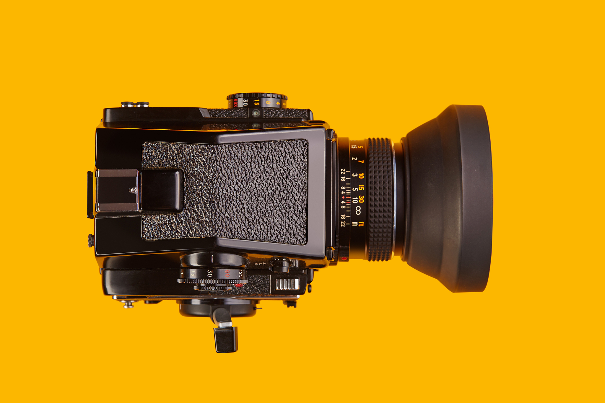 top view of a medium format film camera lying on yellow / orange
