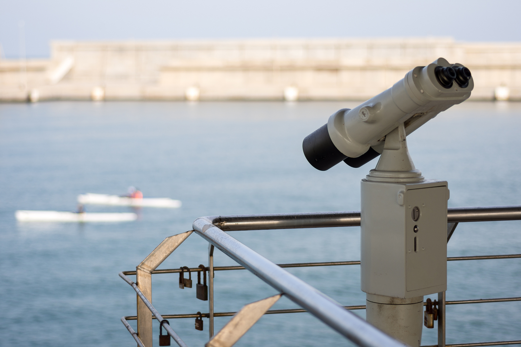 binoculars pointing out to sea and sailing