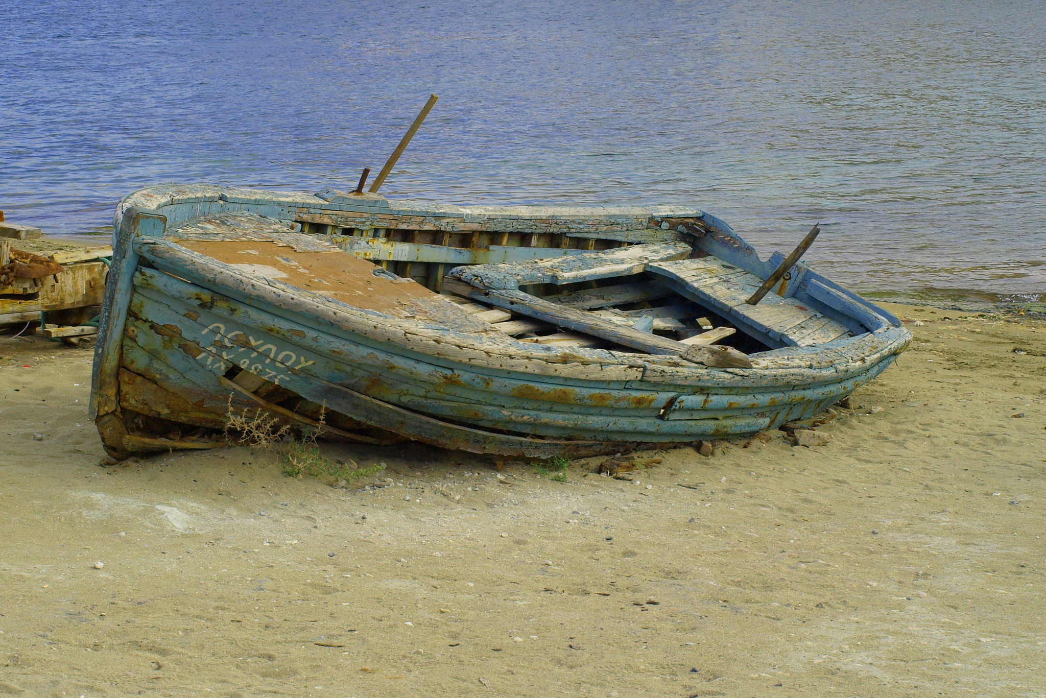 abandoned boat moored on beach