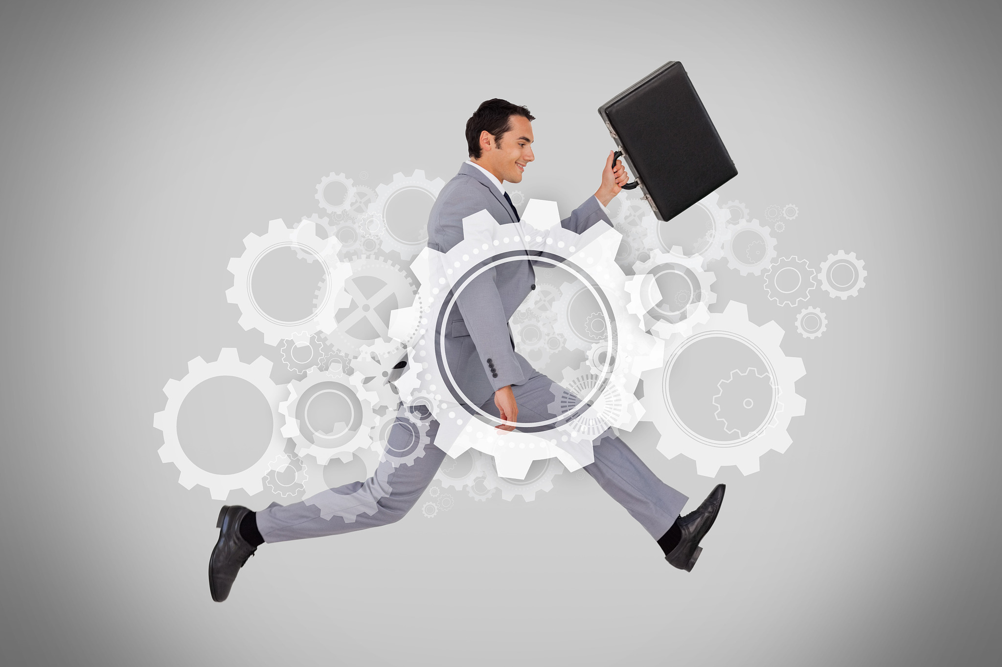 businessman running with briefcase with digital wheels and cogs 