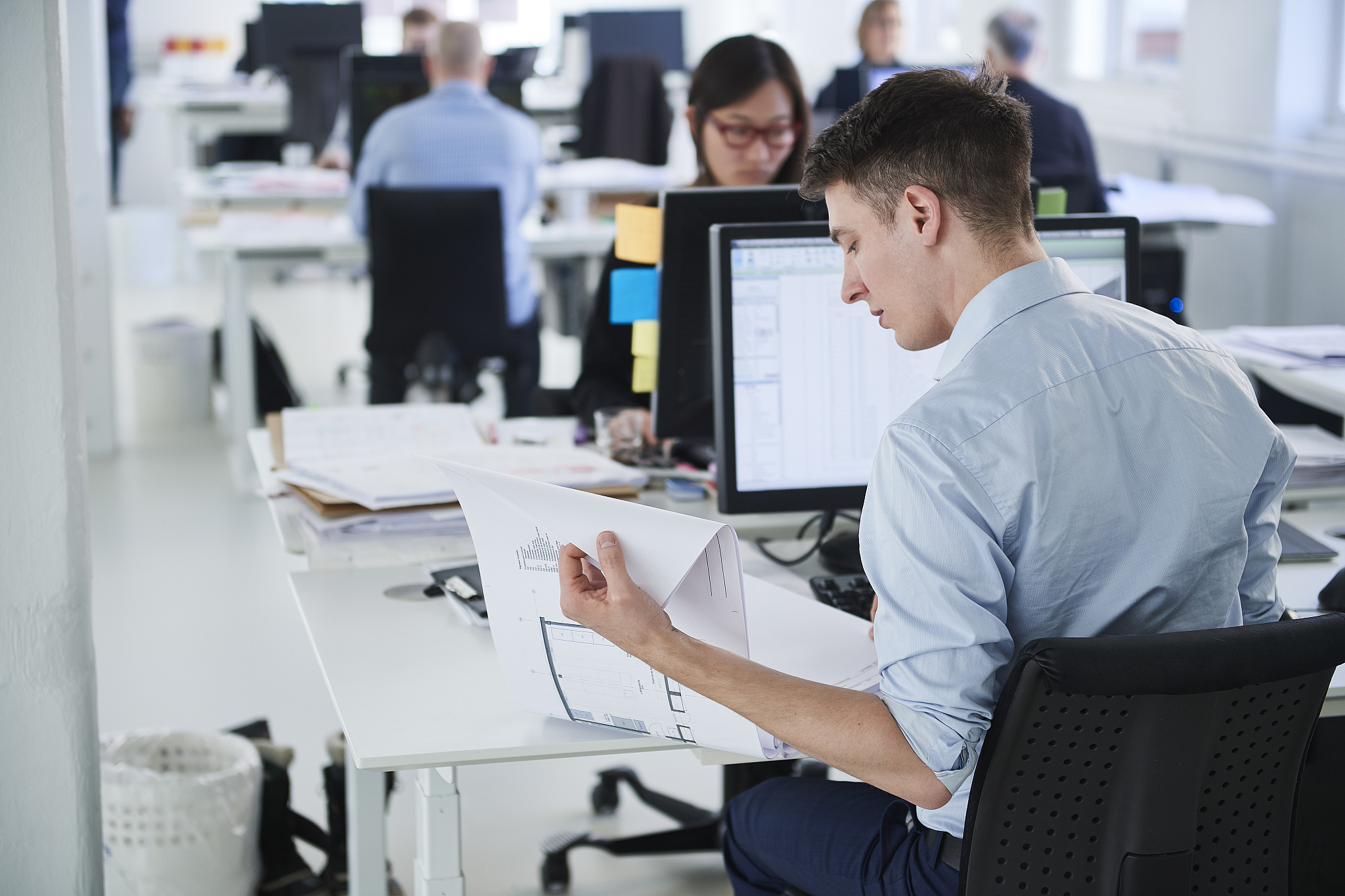 colleagues working in office, using computer