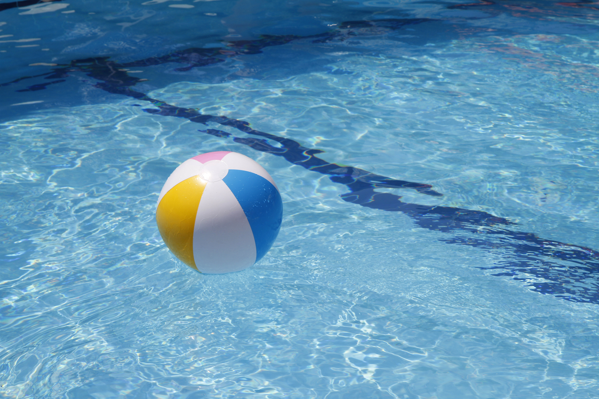 summer beachball floating in a pool on vacation