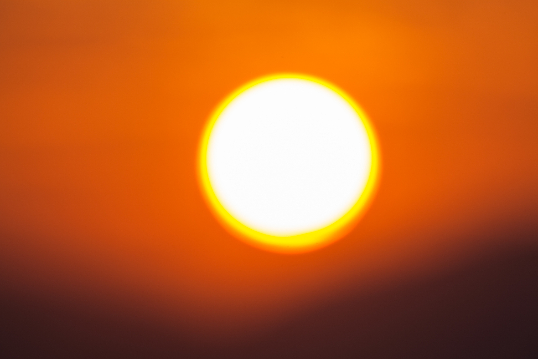 big sun out focus over mountain