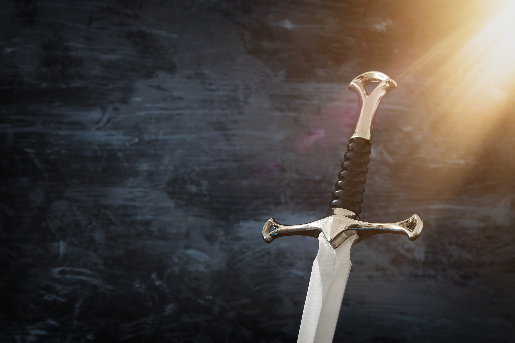 low key image of silver sword. fantasy medieval period.