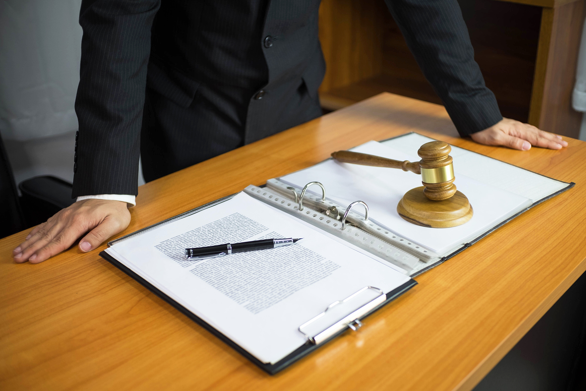 midsection of lawyer standing by file at office