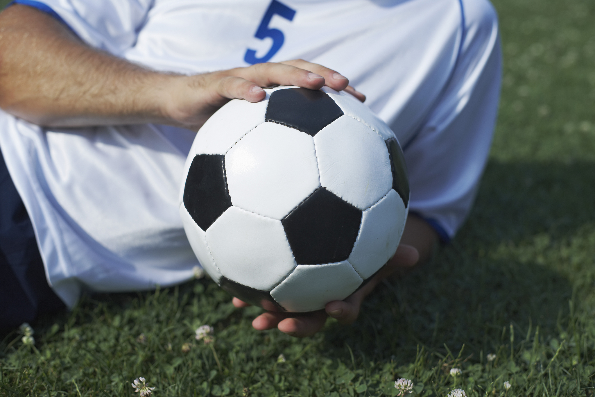 soccer player posing with ball