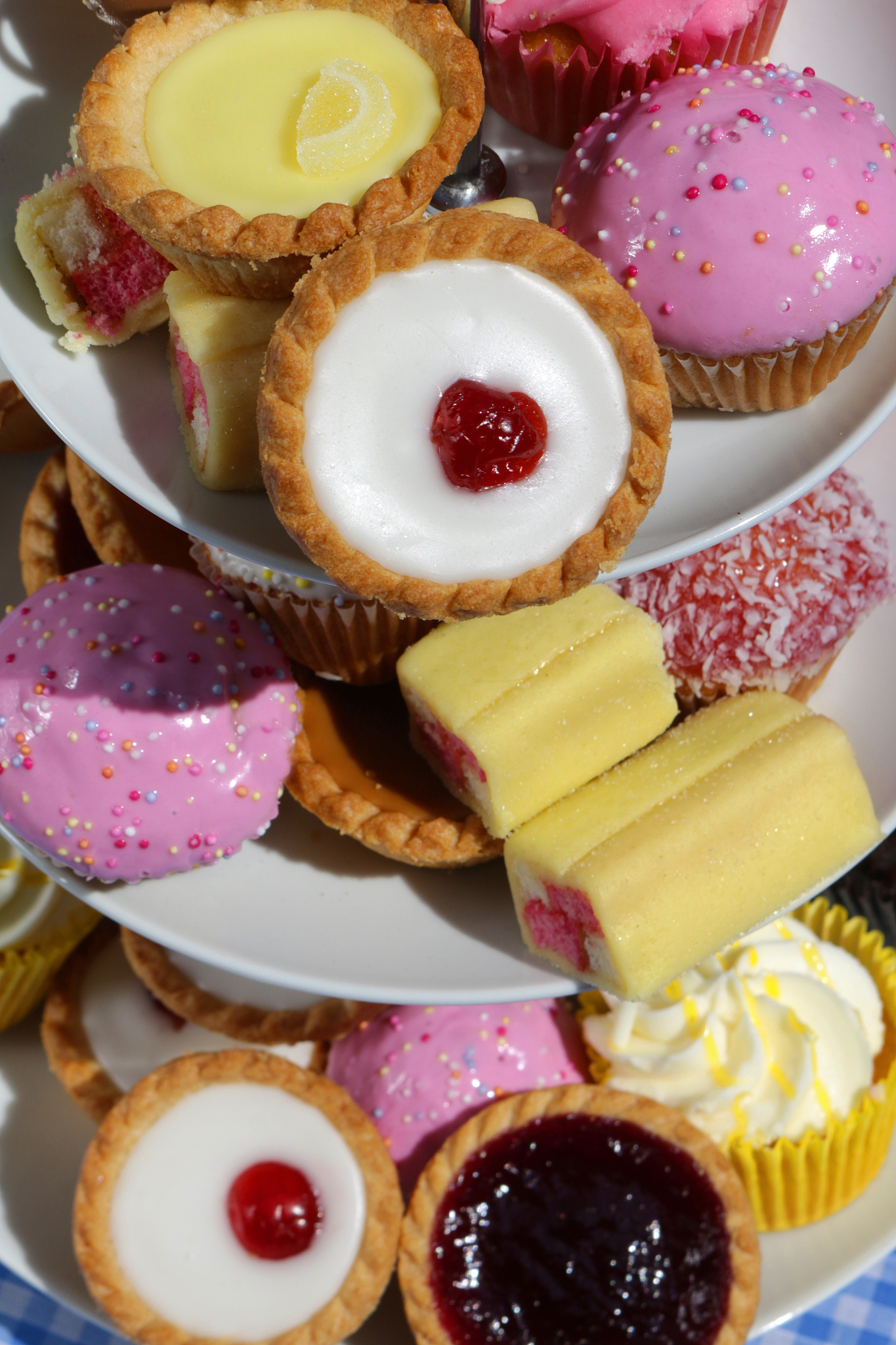 close-up of afternoon tea buffet picnic of cupcakes cakes on whi