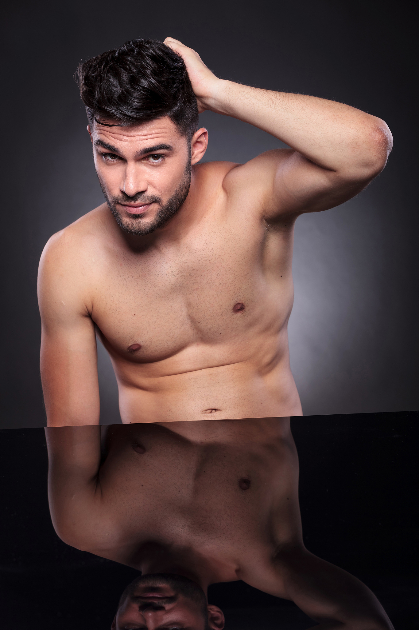 naked young man with hand on his head