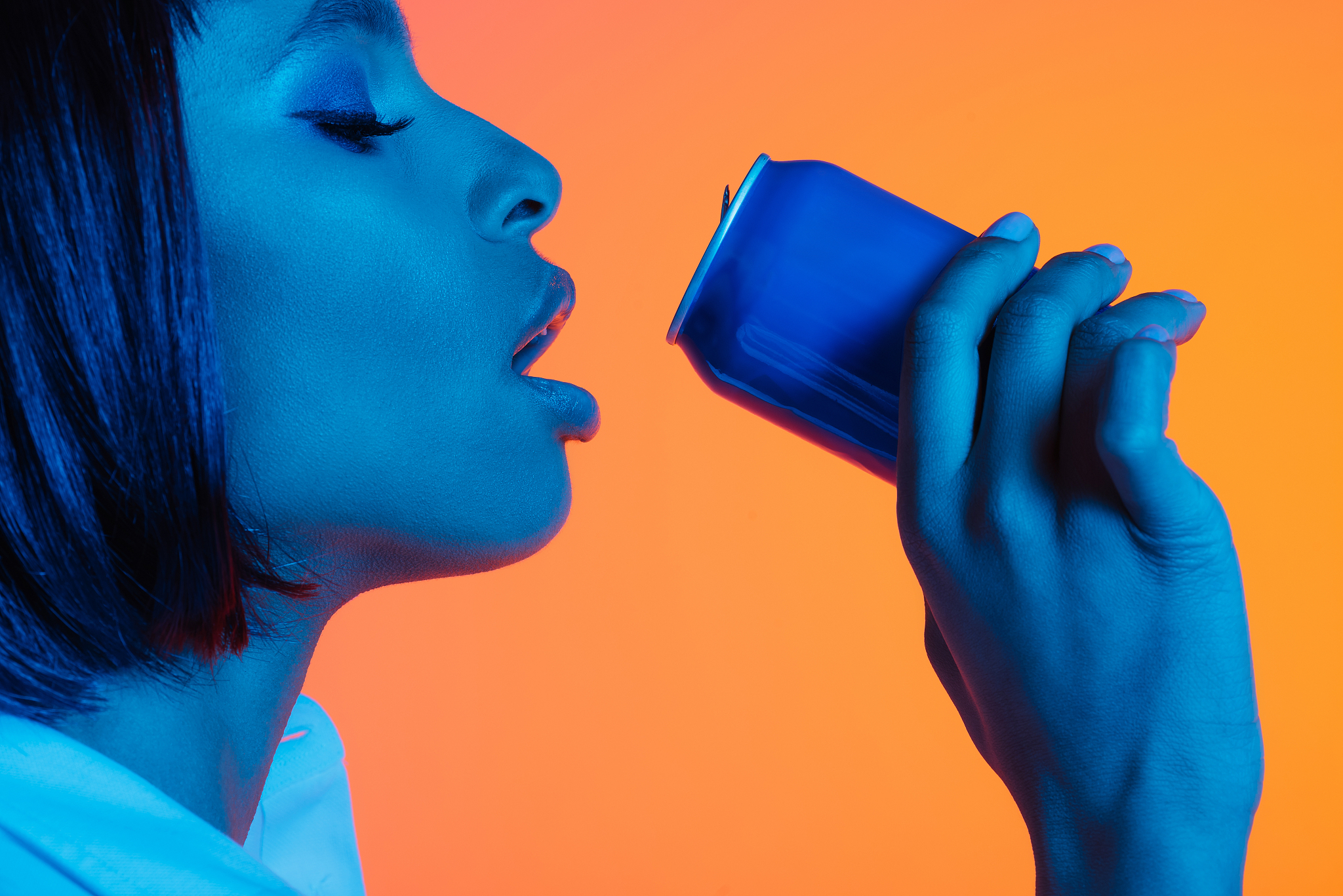 african american girl drinking beverage from can with eyes close