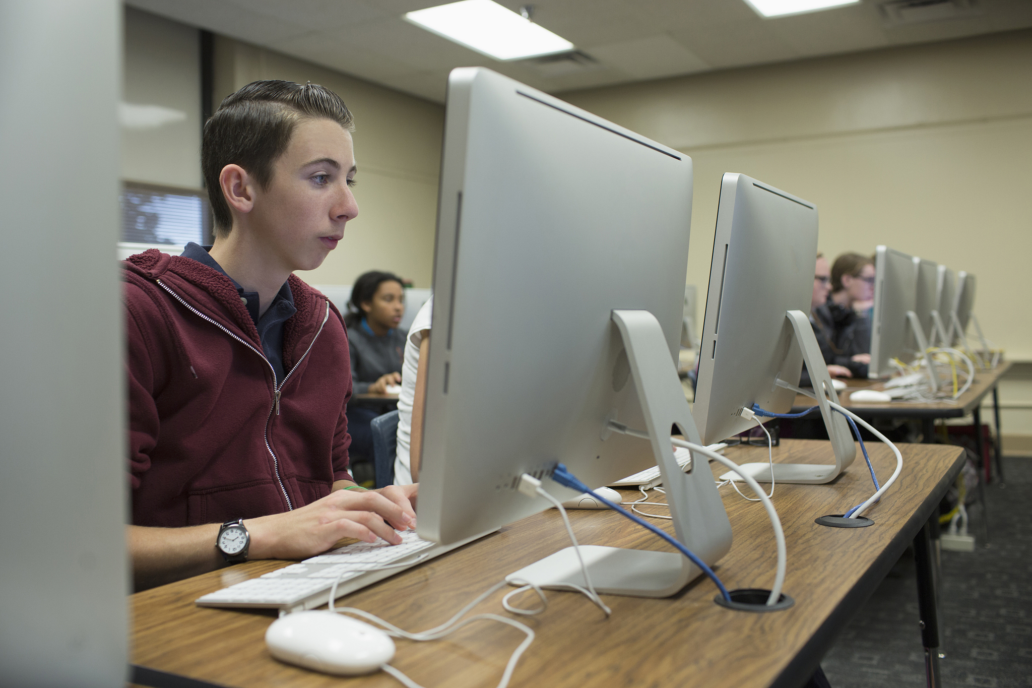 students using computers in classroom