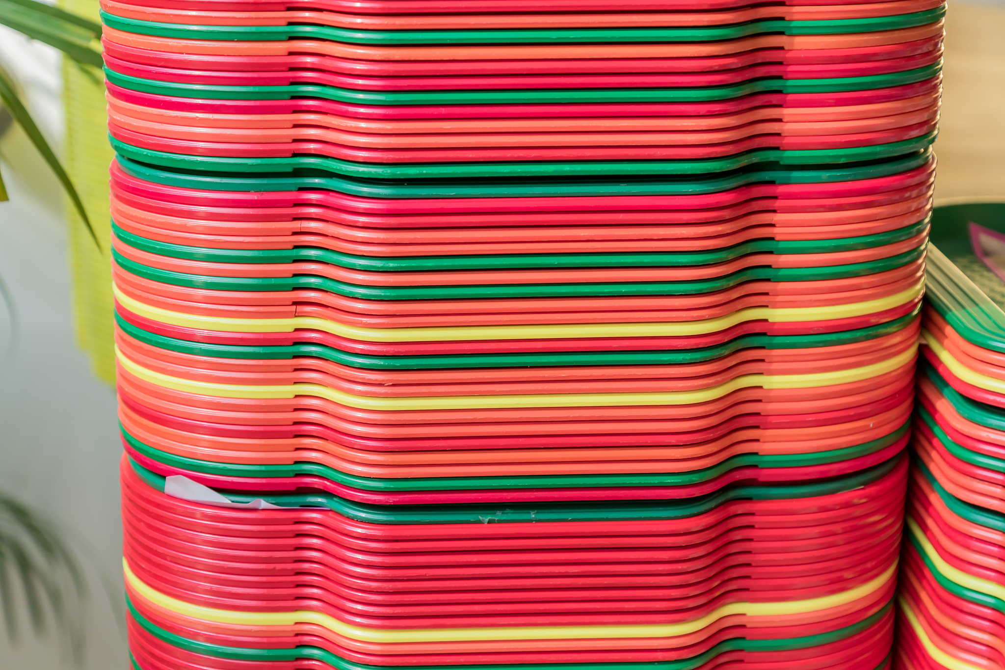 a stack of red, yellow, green trays on the table, close up.