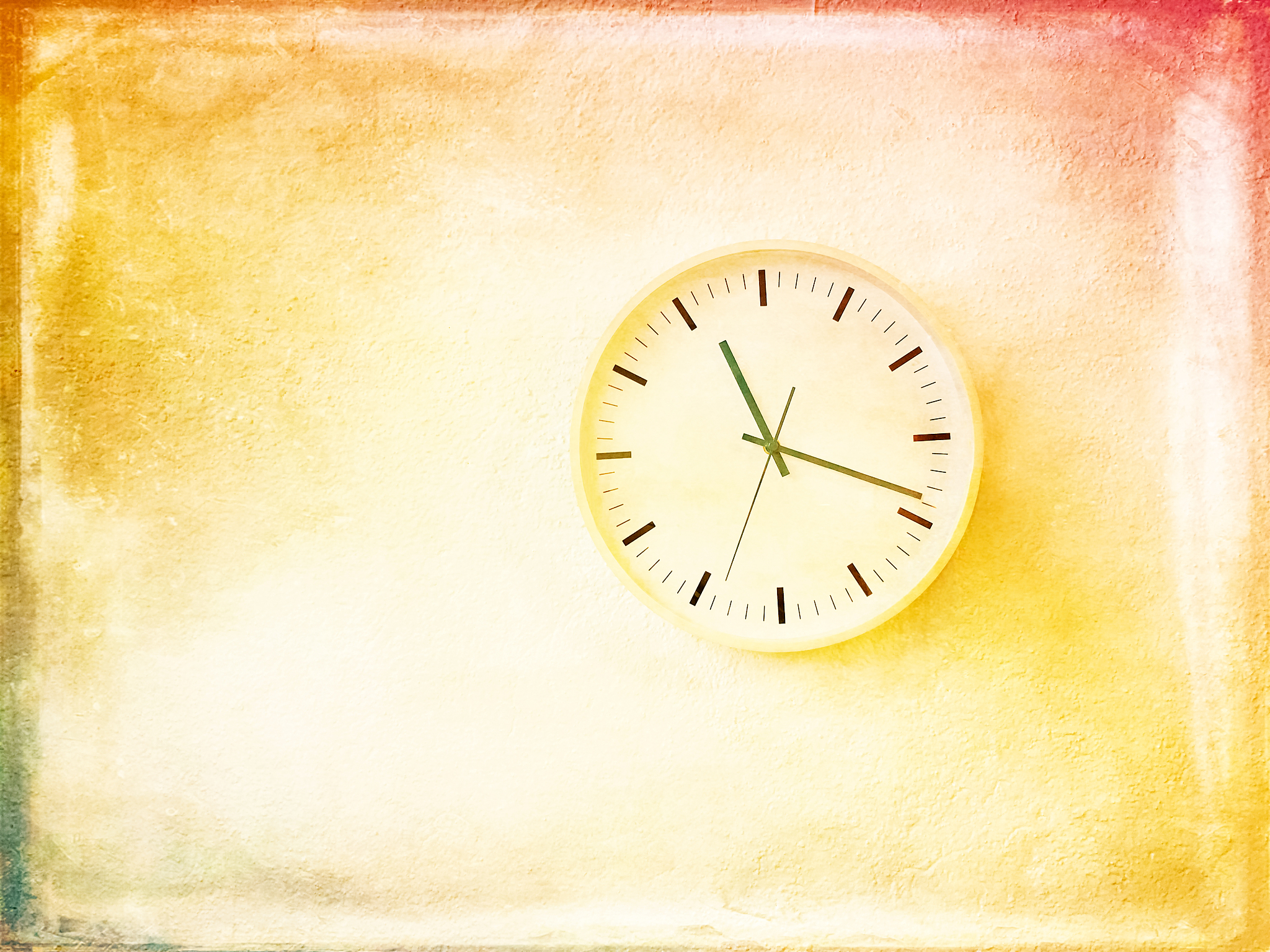 modern round clock on bright painted wall