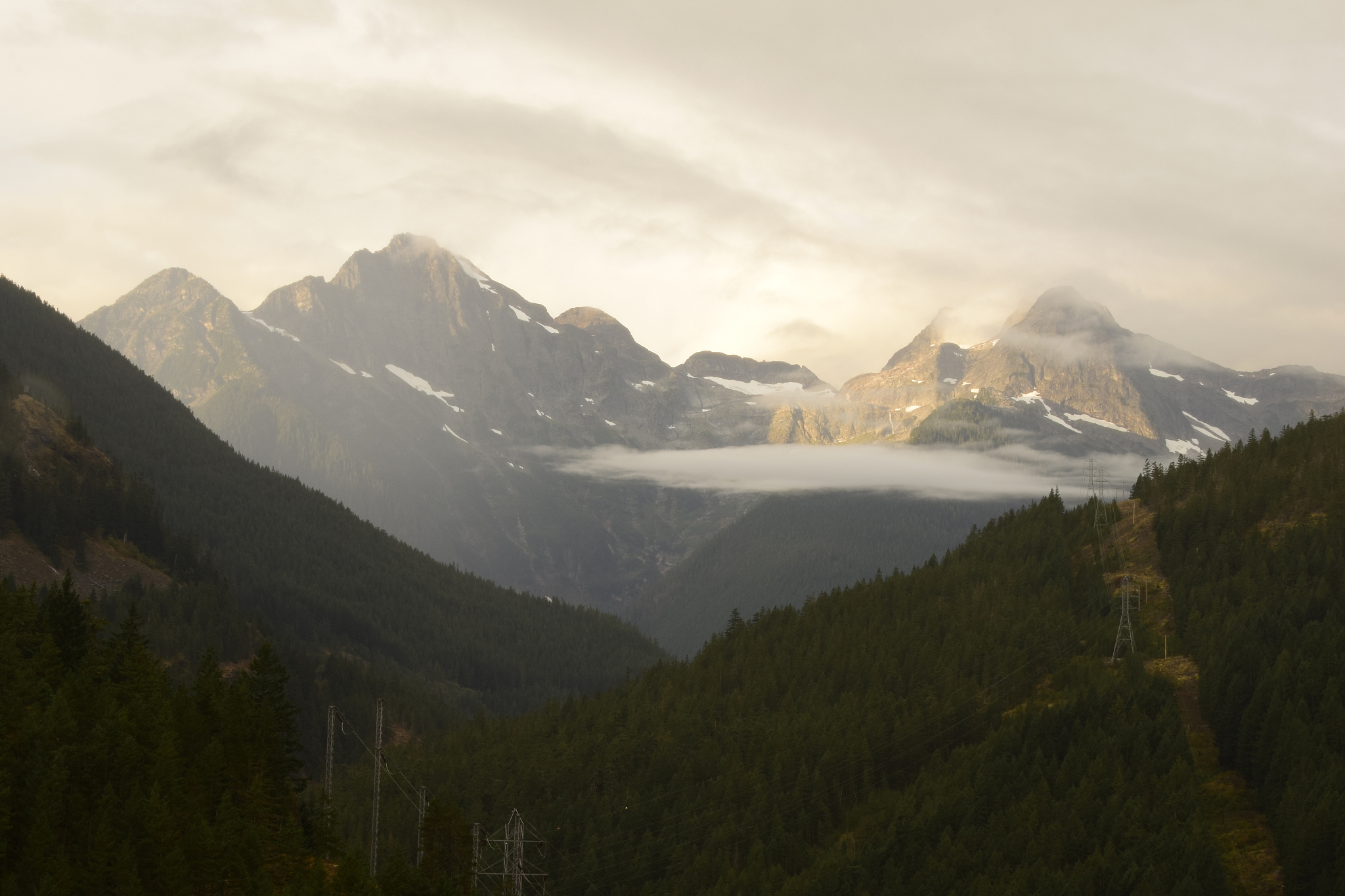 beautiful jagged snowcapped mountain beyond the mountain ridge o