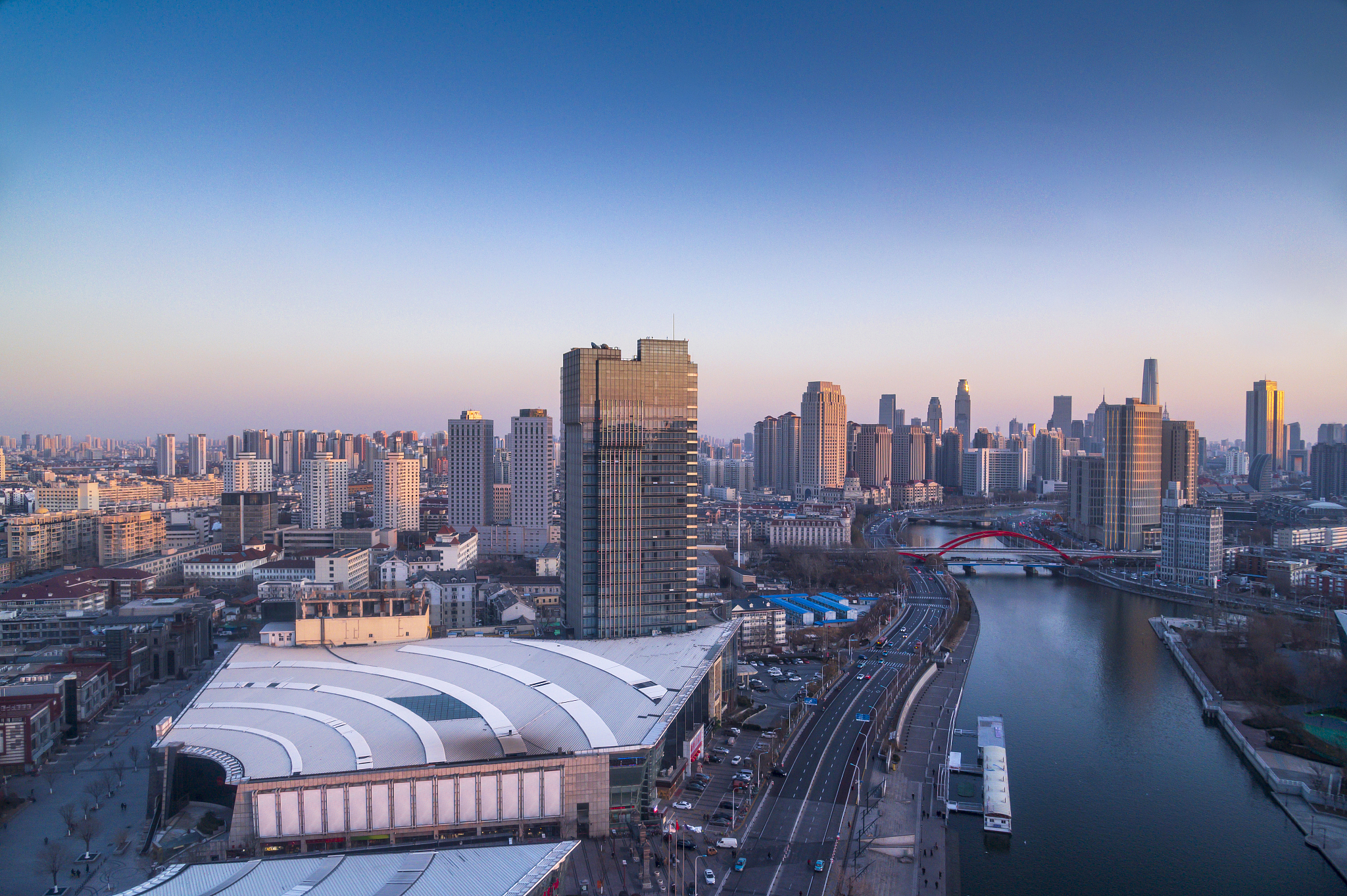 sunset waterfront downtown skyline with tianjin high-rise buildi